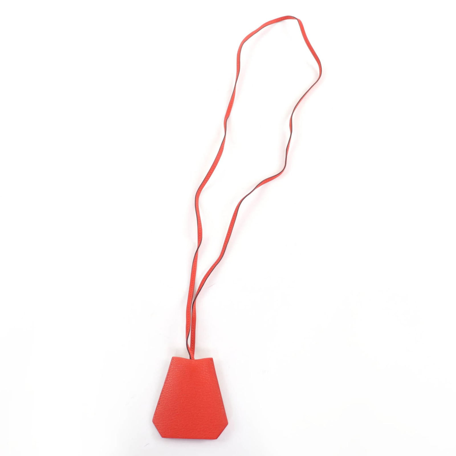 HERMES Chevre Leather: HERMES Chevre Leather Chevre leather from the renowned French brand Hermes, this Capucine-colored necklace boasts a 50cm circumference and features a 80mm x 75mm pendant. Gently used with minor signs 