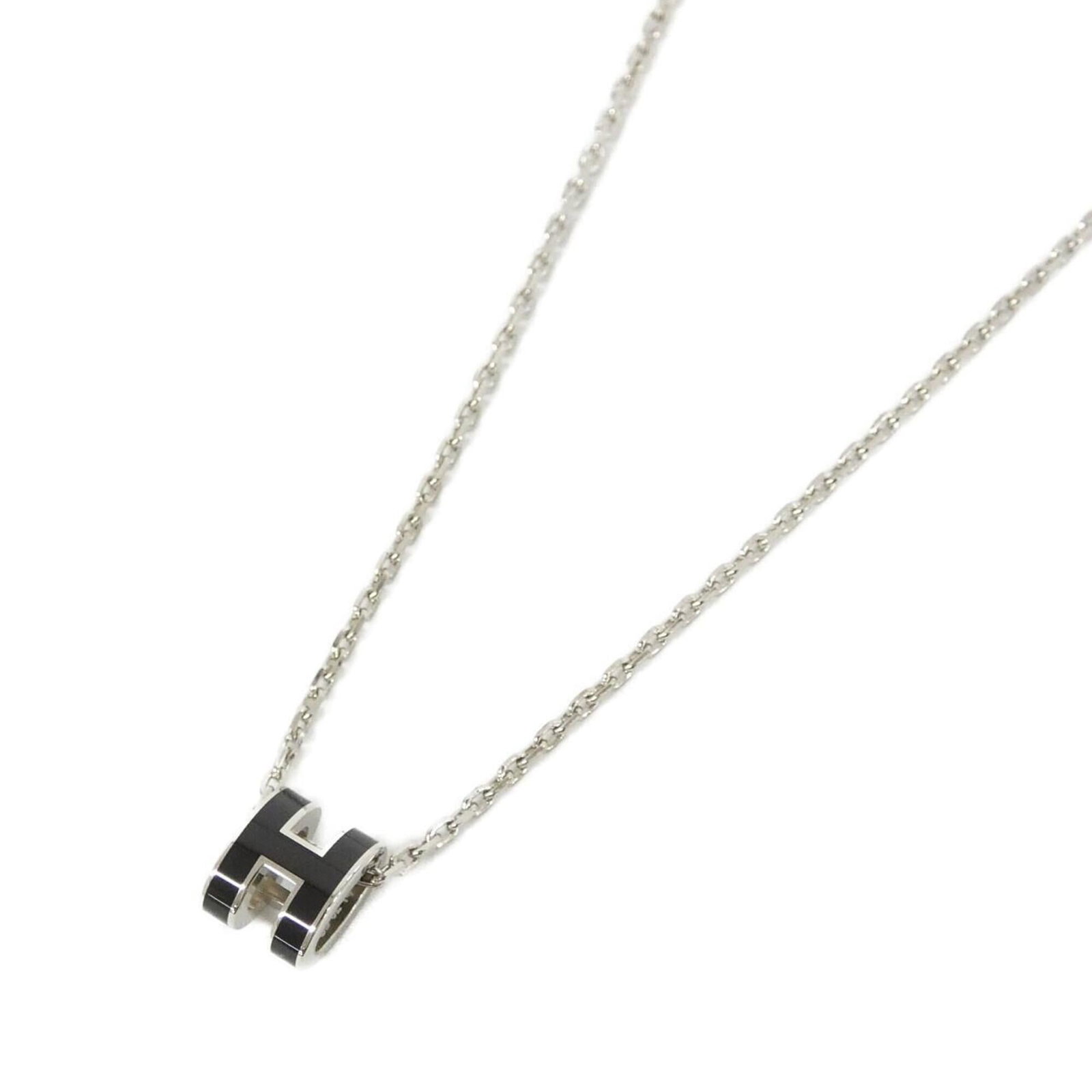 HERMES Black Silver: HERMES Black Silver Black Silver Hermes Necklace, 40 cm, 9mm x 7mm Pendant. This gently used necklace features a 9mm x 7mm black silver pendant, measuring 40 cm in length, with minor signs of wear.