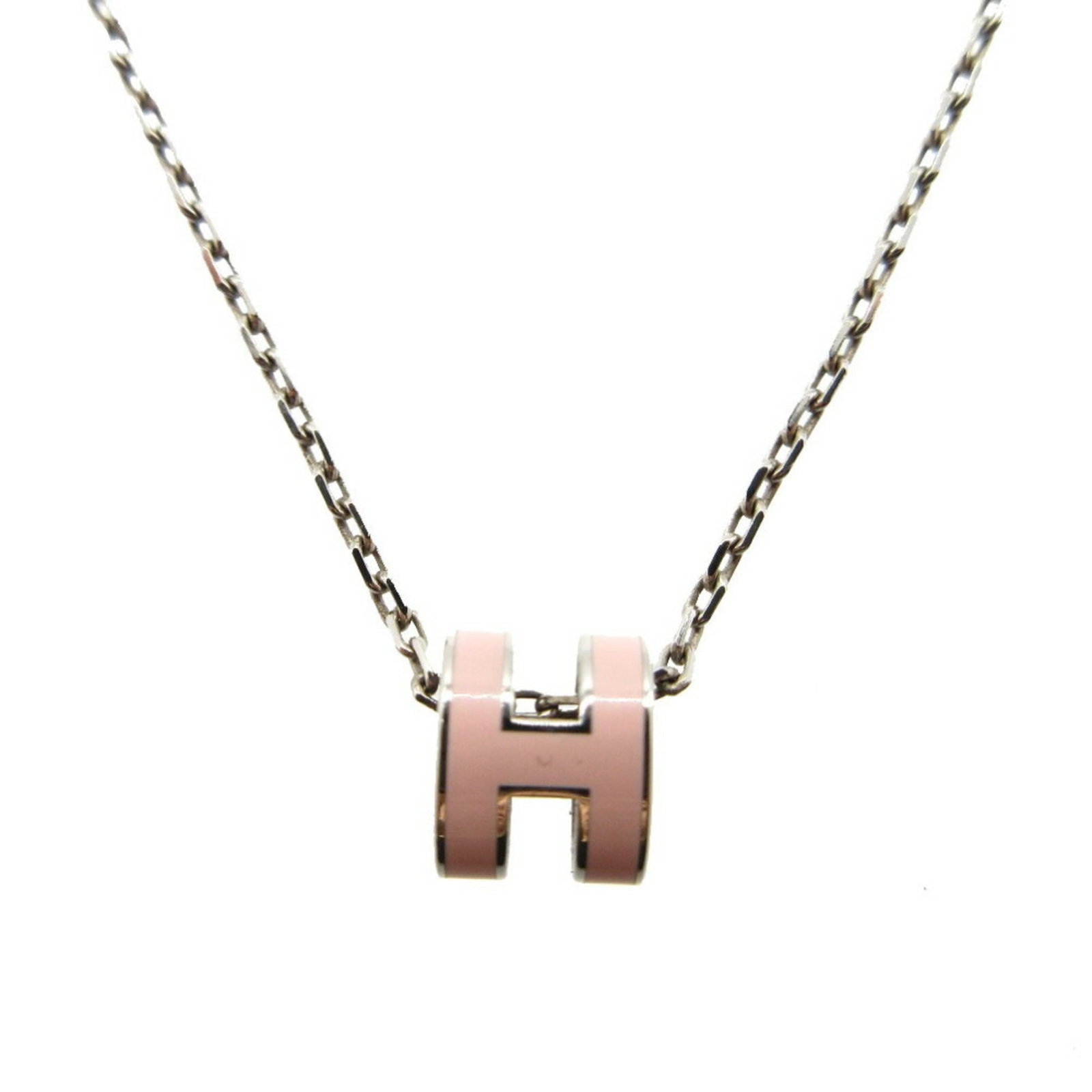 HERMES Metal Pink Silver: HERMES Metal Pink Silver Pink and silver meet in this elegant Hermes Metal Necklace, featuring a 10mm x 8mm pendant in a delicate design. The necklace comes in a 38 cm / 14.96'' length and is