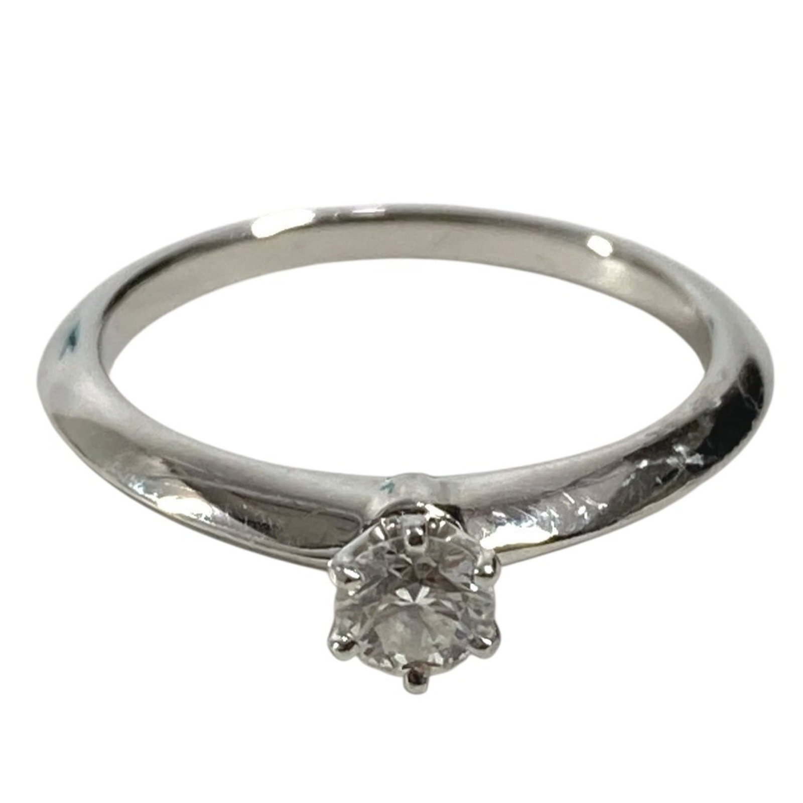 TIFFANY Band Ring Platinum 950: TIFFANY Band Ring Platinum 950 Platinum 950 Tiffany band ring with a 0.22ct diamond, available in a women's size 5.5. This silver band features visible scratches and scuffs, but remains fully