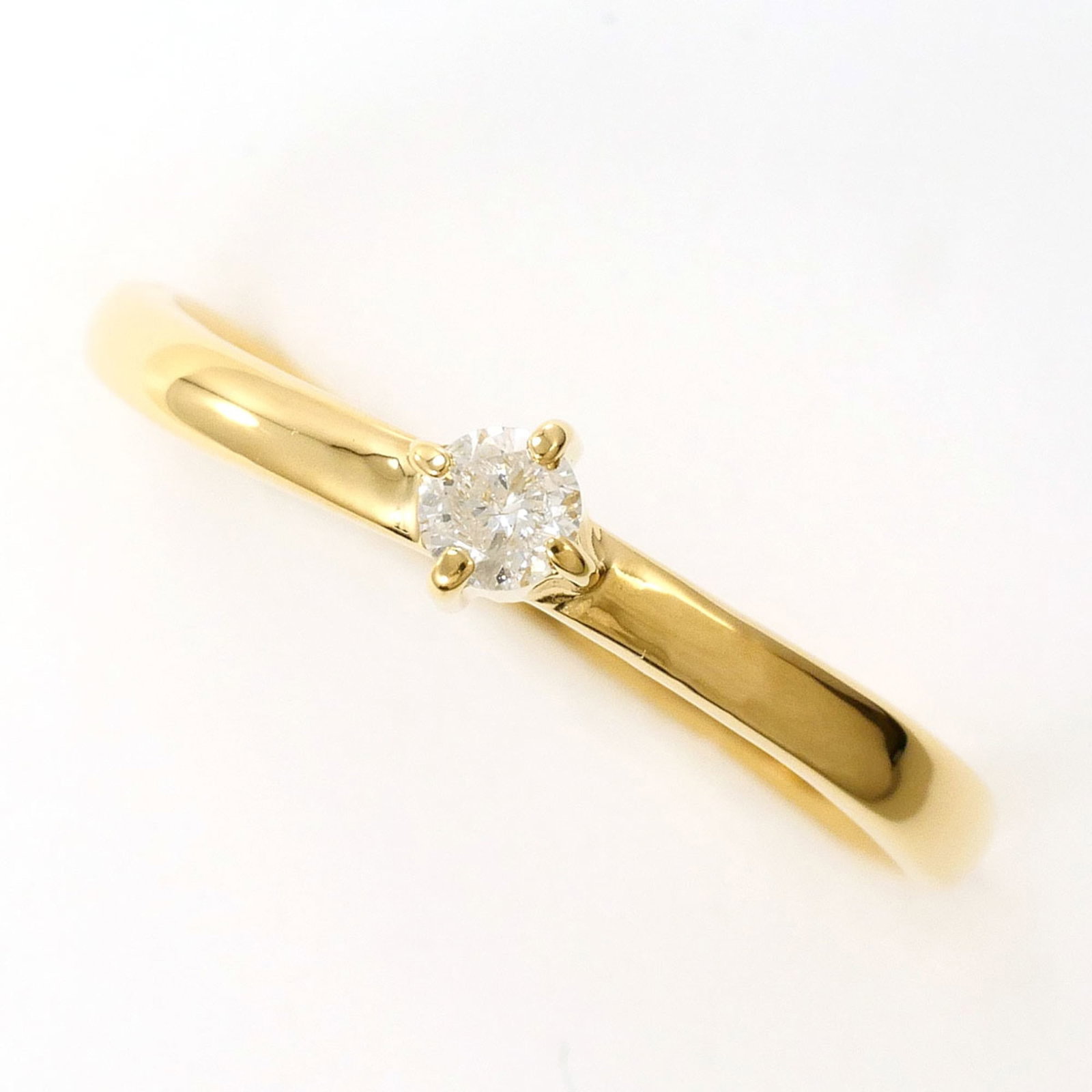Band Ring Yellow Gold (18K): Band Ring Yellow Gold (18K) Yellow gold band ring with a 0.10ct diamond, crafted from 18K metal, offering a touch of elegance and sophistication. This 6.5 US size band features a slim 4mm width and