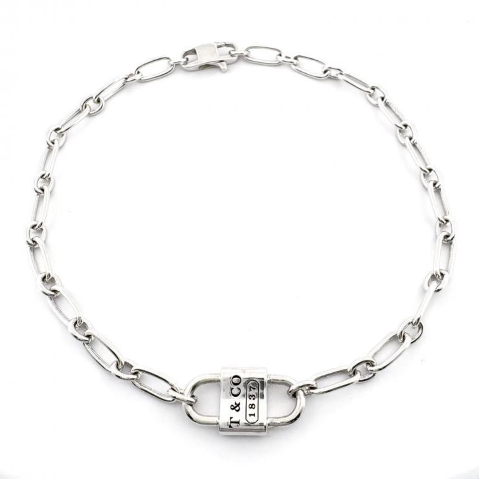 TIFFANY Charm Bracelet Silver 925: TIFFANY Charm Bracelet Silver 925 Silver 925 Tiffany Charm Bracelet with visible scratches and scuffs, offering a unique, worn-in look. This 21.5cm charm bracelet is made from high-quality silver and