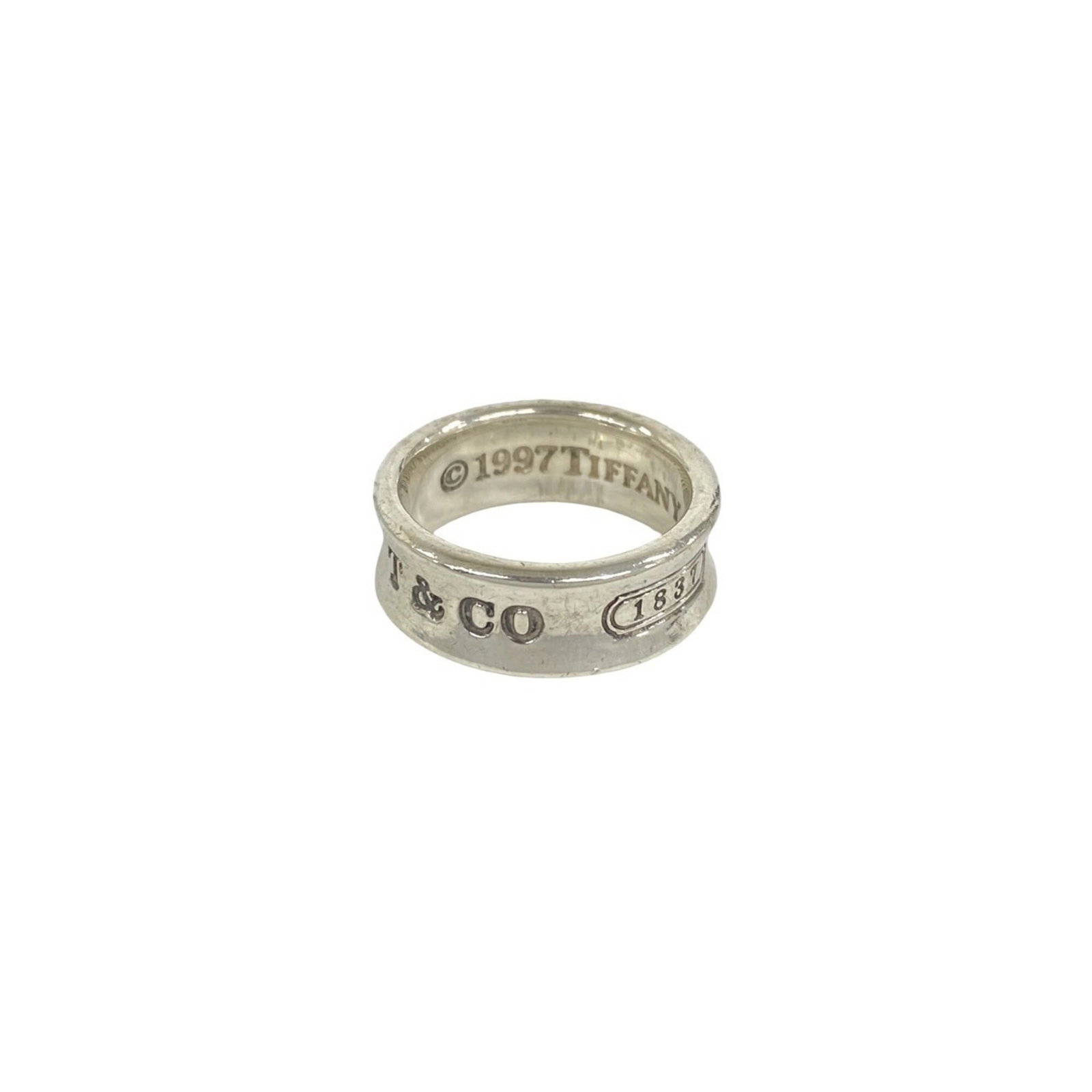 TIFFANY Band Ring Silver 925: TIFFANY Band Ring Silver 925 Silver 925 band ring from Tiffany, a classic design with visible wear, scratches, and scuffs. The item is fully functional and in good overall condition, bearing a signatu