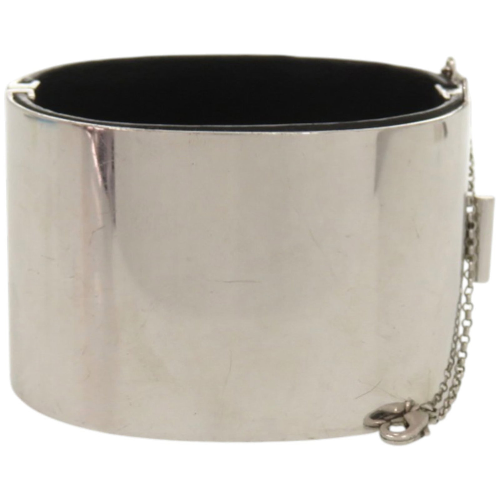 CELINE Bangle Leather Metal: CELINE Bangle Leather Metal This Celine Bangle Leather Metal piece features a sleek black and silver design, with visible scratches and scuffs that add to its worn, used condition. Made from a combina