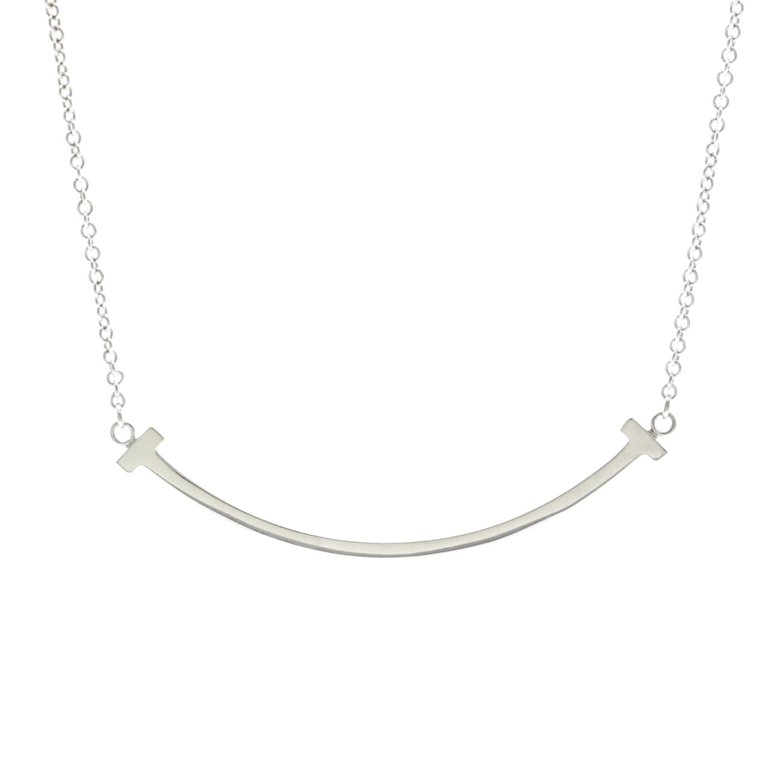 TIFFANY White Gold (18K): TIFFANY White Gold (18K) Small Tiffany T Smile Necklace in White Gold. This 18K white gold necklace features a fashion design with a silver finish, measuring 40.5-45.5 cm in circumference. Gently
