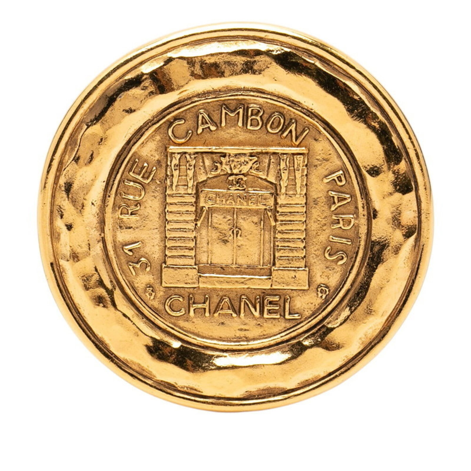 CHANEL Brooch Gold: CHANEL Brooch Gold Gold brooch from the iconic CHANEL brand, featuring a classic design with visible signs of wear, including scratches and scuffs. The item is in good overall condition, with some