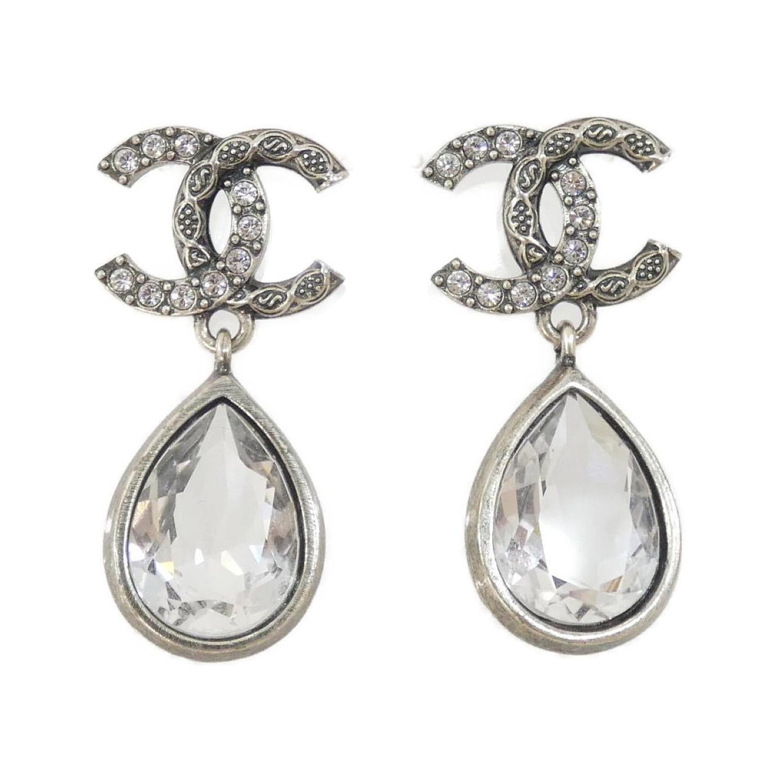 CHANEL Stud Earrings Silver: CHANEL Stud Earrings Silver Stud earrings from the iconic CHANEL brand, featuring a sleek silver design with crystal accents. Gently used, these earrings showcase minor signs of wear, including small 