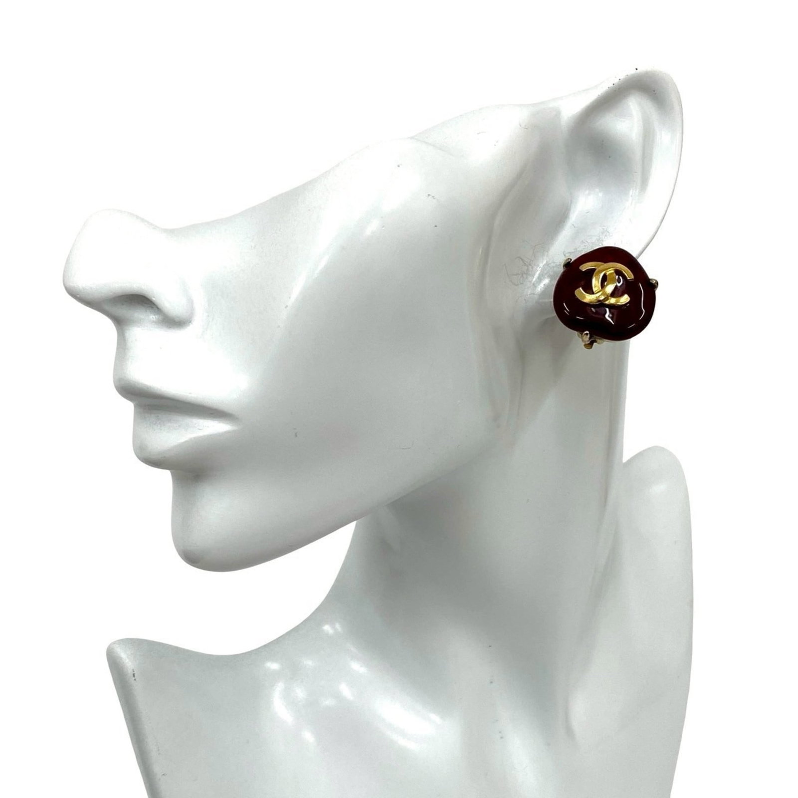 CHANEL Clip Earrings Gold Plating: CHANEL Clip Earrings Gold Plating Gold-plated clip earrings from CHANEL, featuring a classic design with a touch of elegance. The earrings showcase a gold finish with a subtle red accent, adding a pop