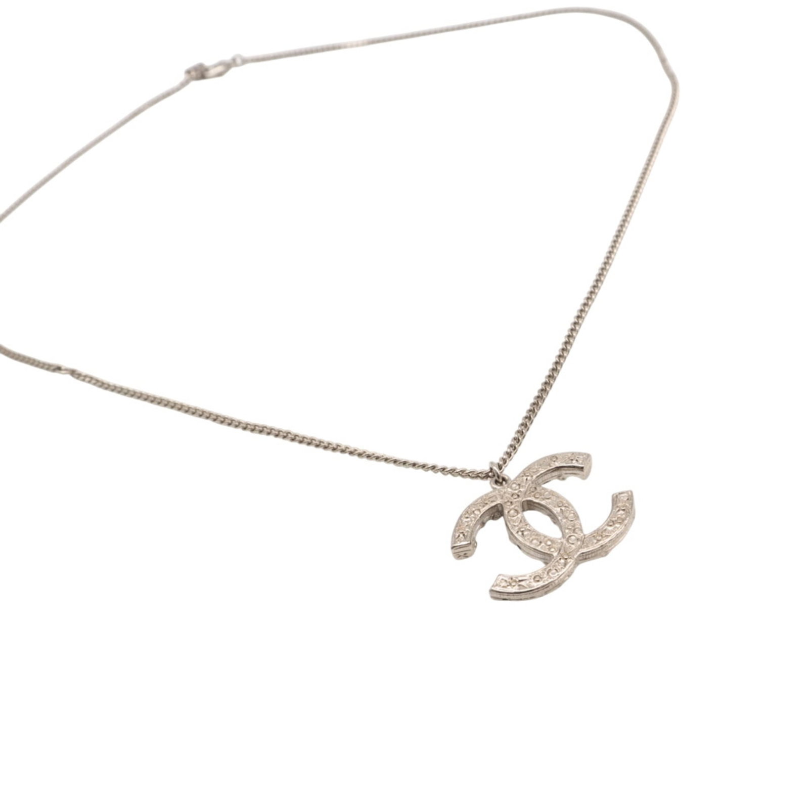 CHANEL Silver Necklace: CHANEL Silver Necklace Silver Rhinestone Chanel Necklace, 31 cm / 12.2'' adjustable neck circumference. This 24mm x 30mm rhinestone pendant is attached to a silver chain, weighing 14g / 0.49oz. The