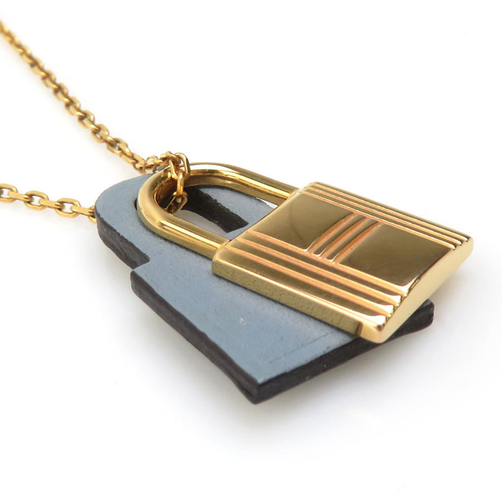 HERMES Leather Metal: HERMES Leather Metal Gold and Gray Hermes Leather Metal Necklace. This 50cm gold and gray leather metal necklace features a 25mm x 15mm pendant, showcasing the intricate details of Hermes craftsmanshi