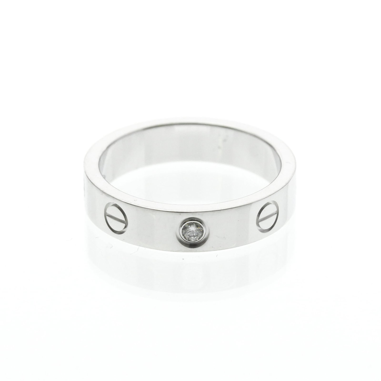 CARTIER Band Ring White Gold (18K): CARTIER Band Ring White Gold (18K) Cartier's Mini Love Ring is a stylish band ring featuring a diamond set in 18K white gold. This gently used ring boasts a slender 4mm width and weighs 3.8g, making