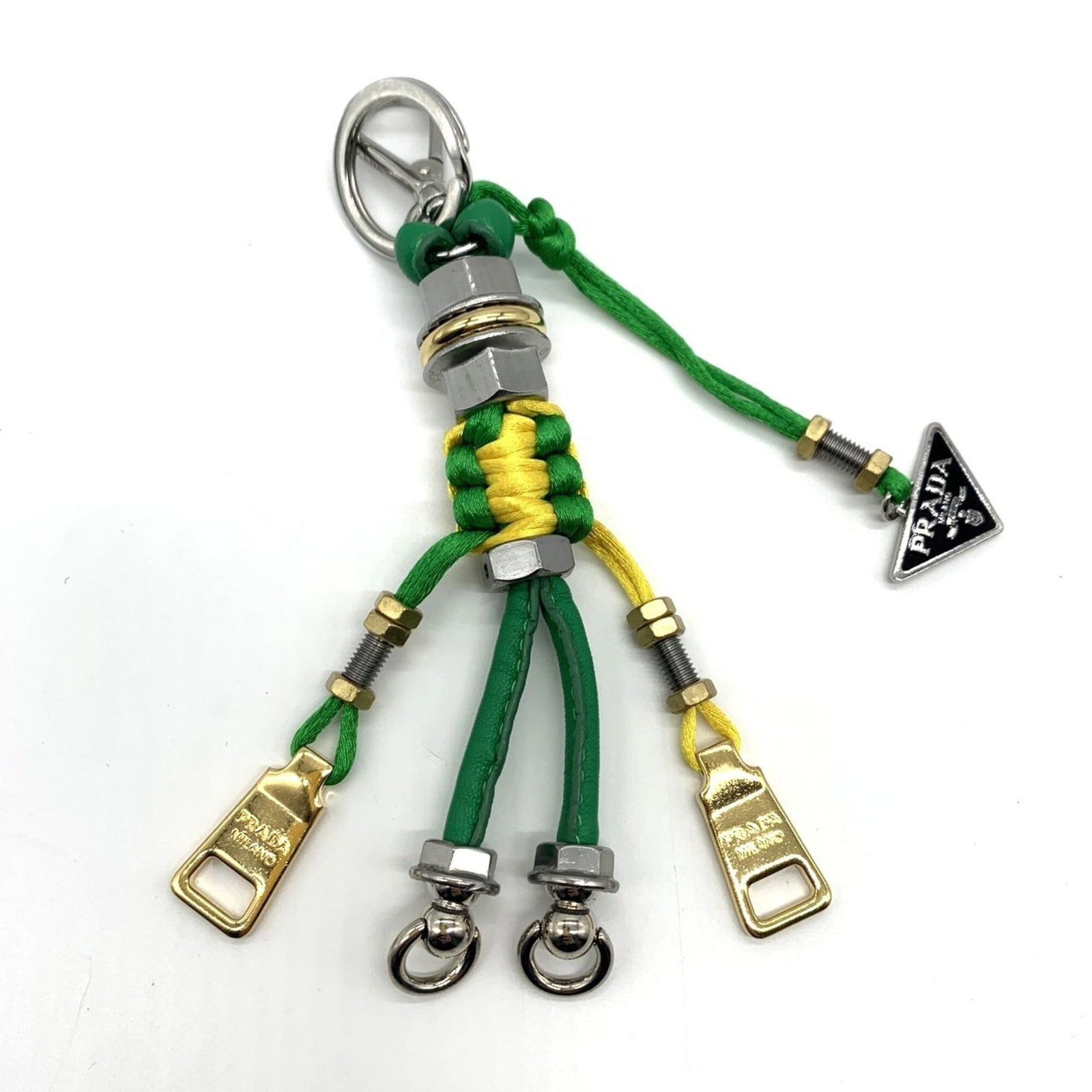 PRADA Handbag Charm Leather Metal: PRADA Handbag Charm Leather Metal Leather and metal come together in this Prada handbag charm, featuring a striking green color. The item boasts a distinctive design with visible wear and scratches,