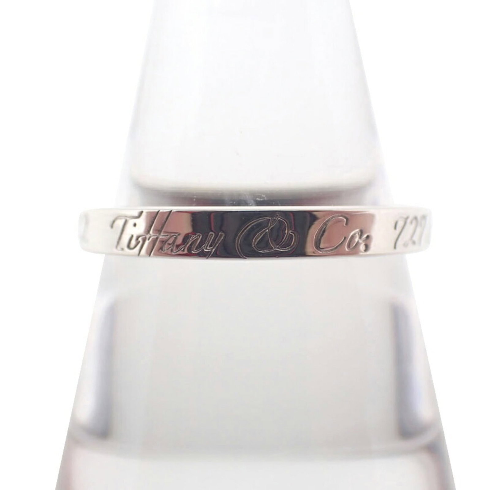 TIFFANY Band Ring Sterling Silver 925: TIFFANY Band Ring Sterling Silver 925 Sterling silver 925 band ring from Tiffany, featuring a sleek and modern design. This like new used ring boasts excellent condition with no visible wear, making i