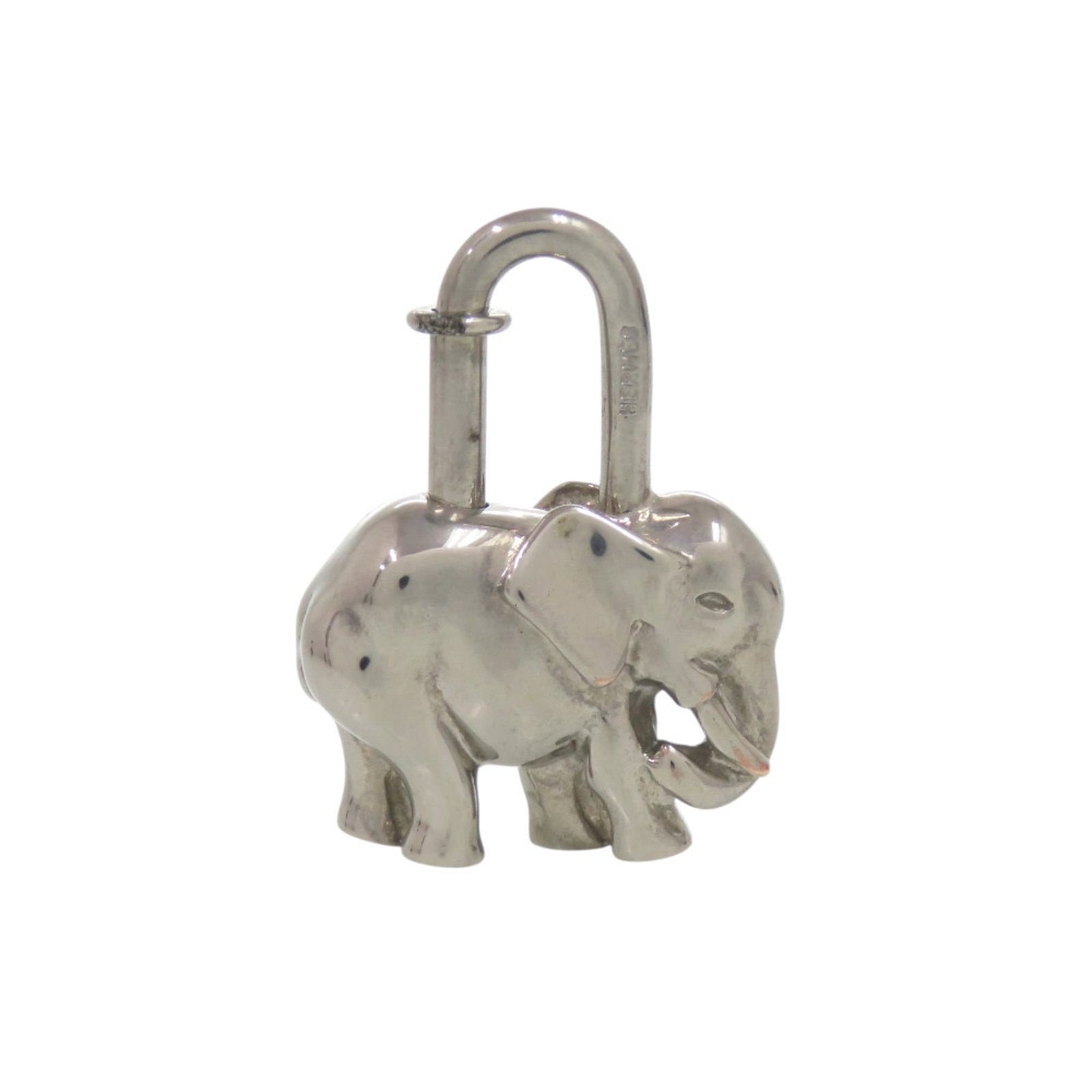 HERMES Handbag Charm Metal: HERMES Handbag Charm Metal Silver Hermes Handbag Charm Metal. This metal charm features the iconic Hermes brand and measures 35.00mm x 30.00mm x 10.00mm. With visible scratches and scuffs, it is a