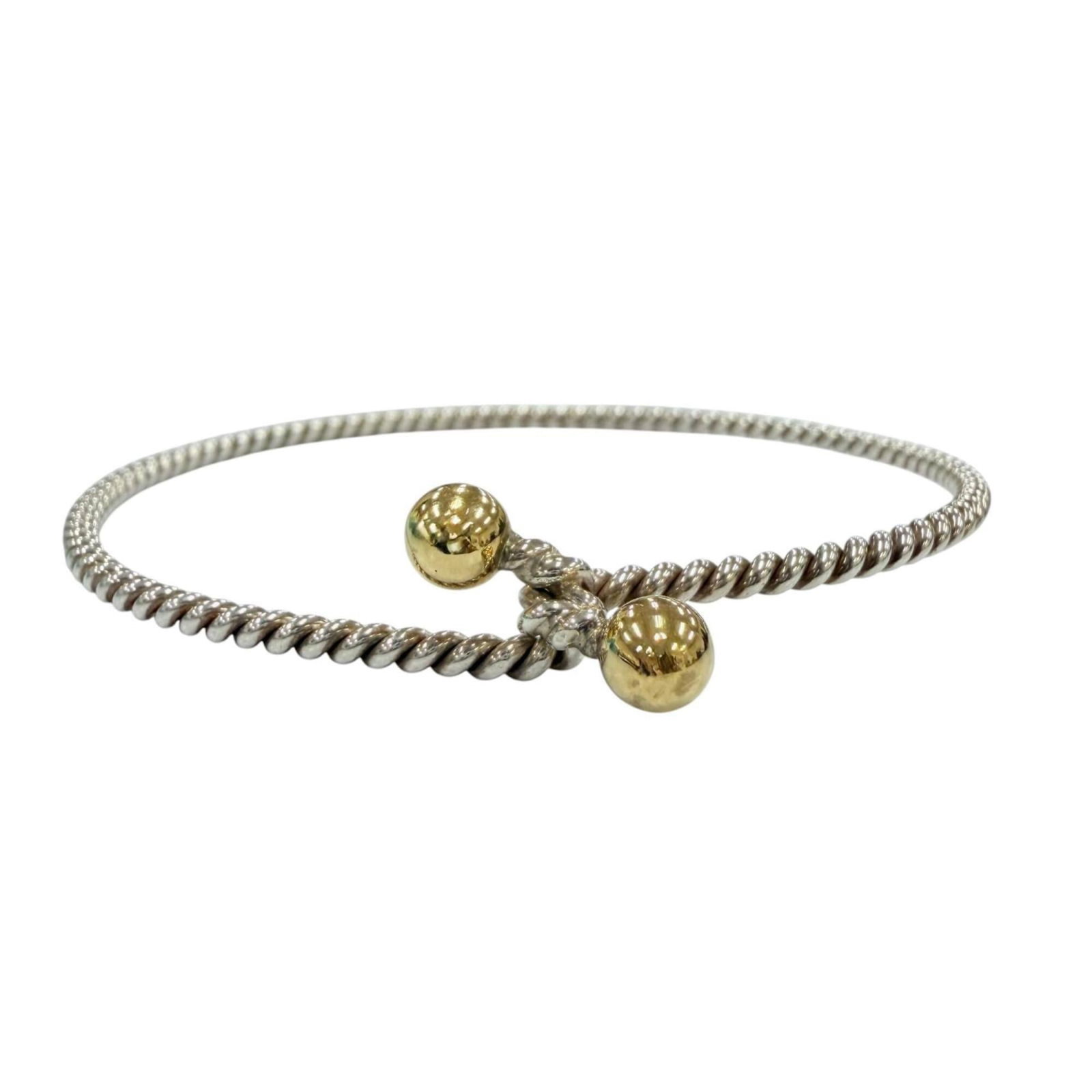 TIFFANY Bangle Silver 925 Yellow Gold (18K): TIFFANY Bangle Silver 925 Yellow Gold (18K) Silver 925 and 18K yellow gold come together in this elegant bangle, crafted by Tiffany. The bangle's slender design and subtle yellow gold accents add a