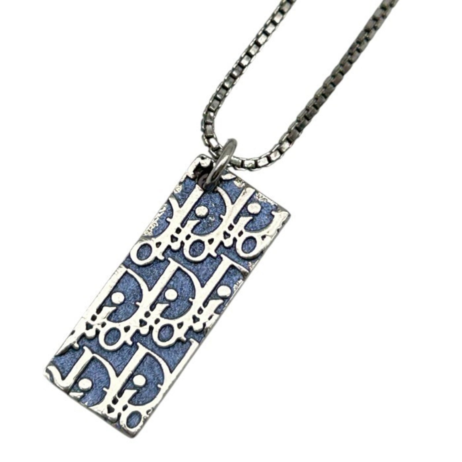 CHRISTIAN DIOR Blue Silver: CHRISTIAN DIOR Blue Silver Blue Silver Necklace by Christian Dior, featuring a striking blue and silver pendant, is a unique and eye-catching accessory for women. Measuring 25mm x 10mm, the pendant