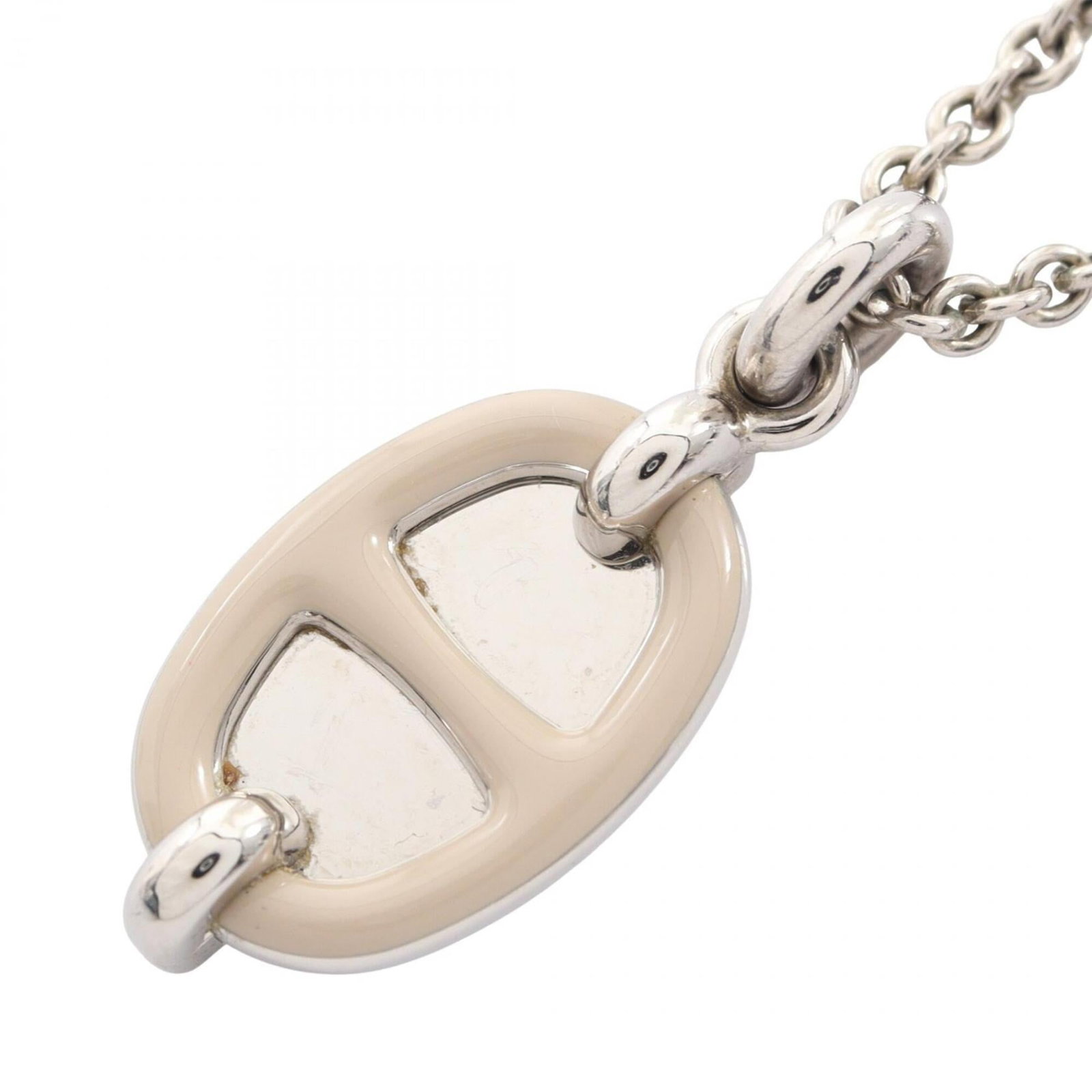 HERMES Stainless Steel: HERMES Stainless Steel Stainless steel necklace from Hermes, featuring a beige pendant with a 20mm x 12mm design. The necklace is adjustable in length, ranging from 42 cm to 47 cm, and is made from