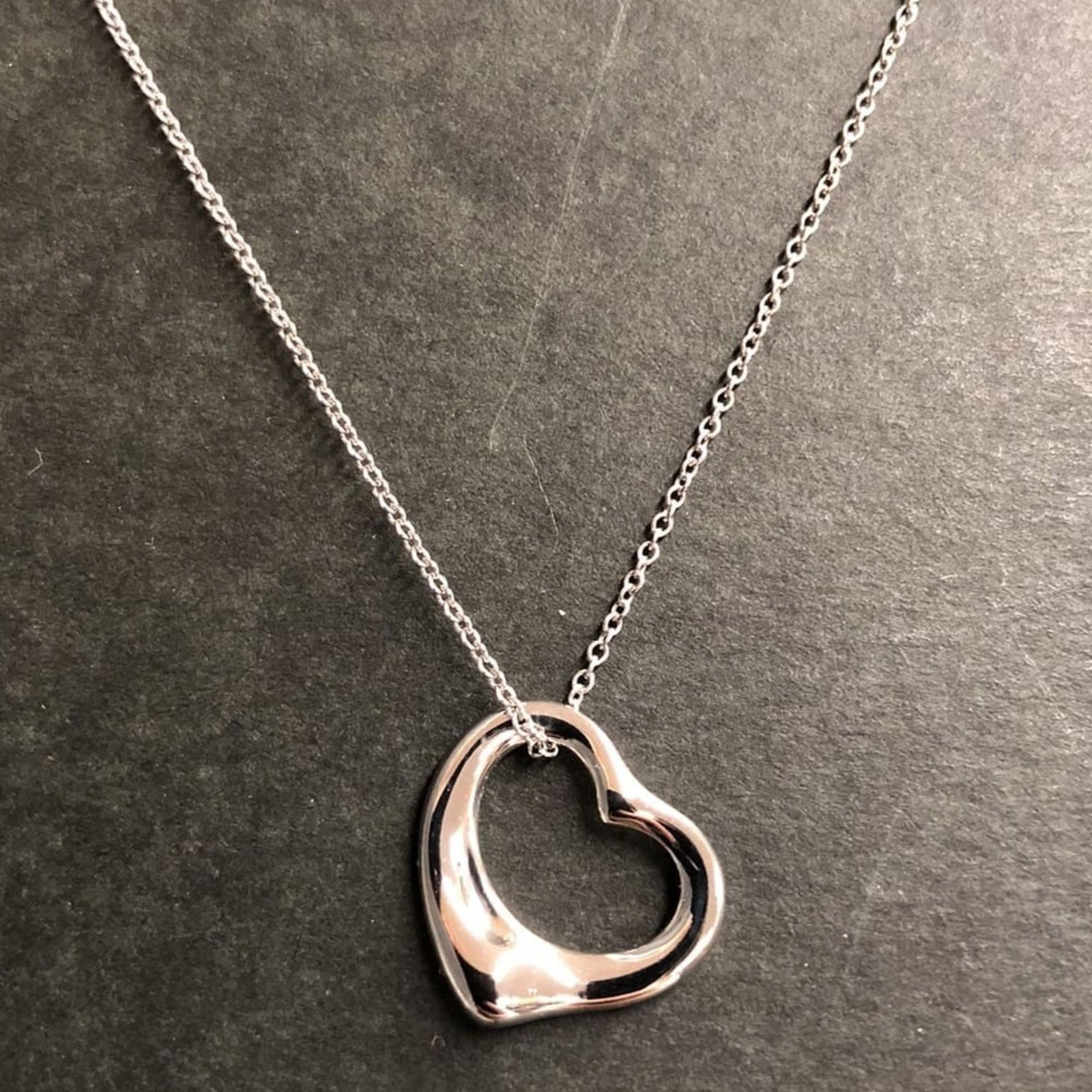 TIFFANY Platinum 950: TIFFANY Platinum 950 Platinum 950 Tiffany Necklace in Very Good Condition. This silver pendant necklace features a 13mm x 15mm platinum 950 pendant, gently used with minor signs of wear. Small scratch