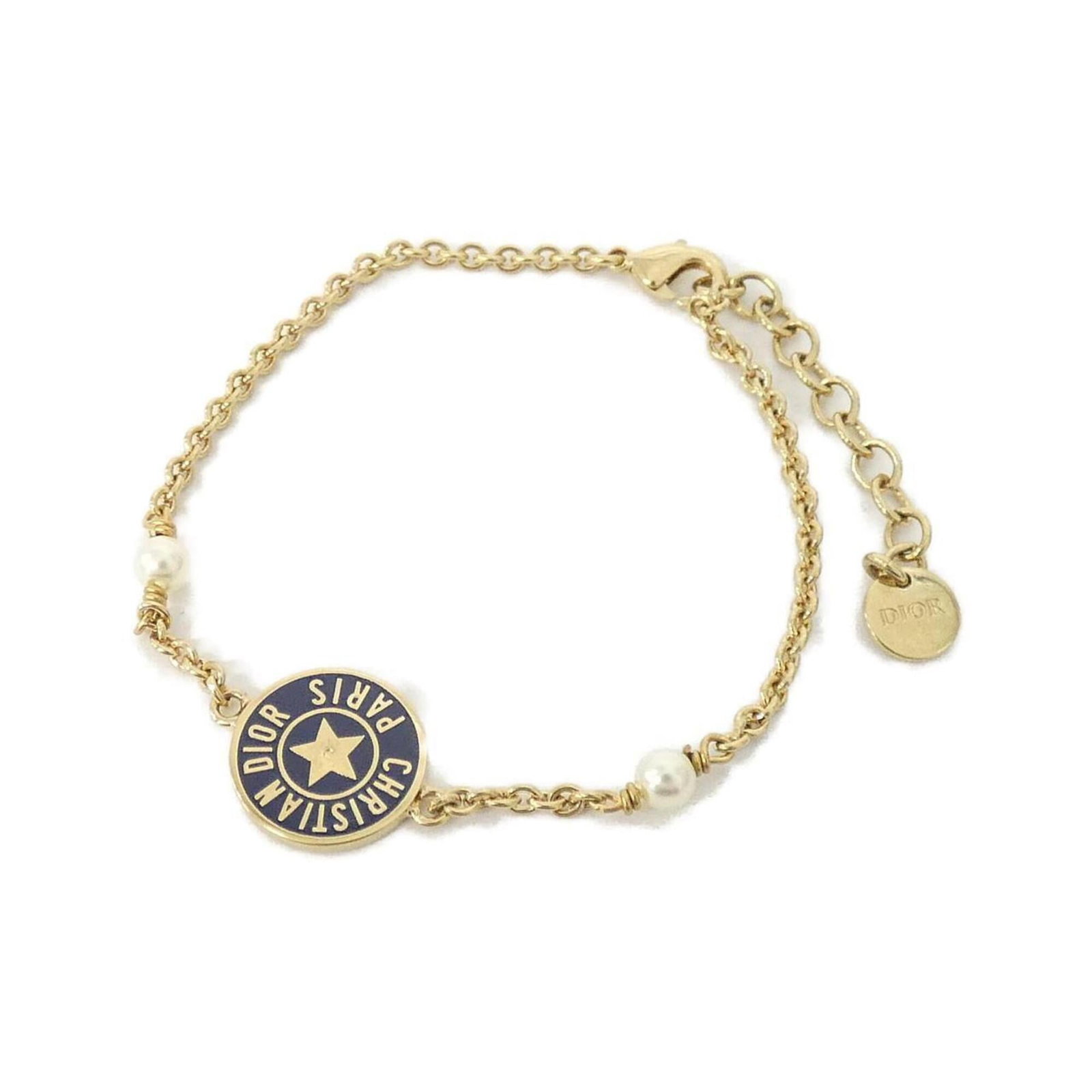 CHRISTIAN DIOR Charm Bracelet Gold Navy White: CHRISTIAN DIOR Charm Bracelet Gold Navy White Gold, Navy, and White charm bracelet from Christian Dior, featuring a delicate gold chain with navy and white charms. Measuring 16.5-20cm in length, this 