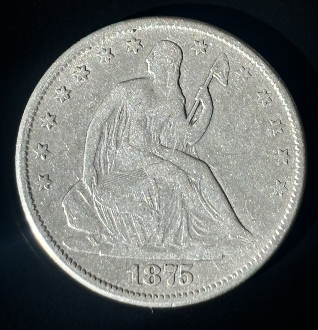 SEATED LIBERTY HALF DOLLAR CHOICE VF DETAILS: SEATED LIBERTY HALF DOLLAR CHOICE VF DETAILS Seated Liberty Half Dollar 1875: A Circulated Silver Coin with Ungraded Details. This 1875 Seated Liberty Half Dollar is a circulated coin with a silver co