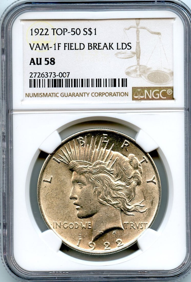 C9064- 1922 VAM-1F FIELD BREAK LDS TOP 50 PEACE DOLLAR NGC AU58: C9064- 1922 VAM-1F FIELD BREAK LDS TOP 50 PEACE DOLLAR NGC AU58 The 1922 VAM-1F Field Break LDS Top 50 Peace Dollar features a unique field break on the reverse, a distinctive characteristic among cir