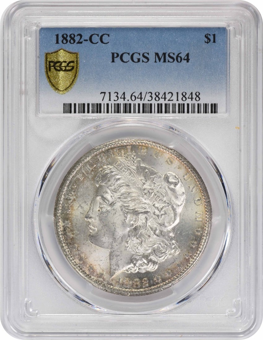 Morgan Silver Dollar MS64 CC 1882: Morgan Silver Dollar MS64 CC 1882 MS64 Morgan Silver Dollar from 1882, certified by PCGS as Uncirculated, boasts a striking design by George T. Morgan, with a diameter of 38.10 millimeters and a reede