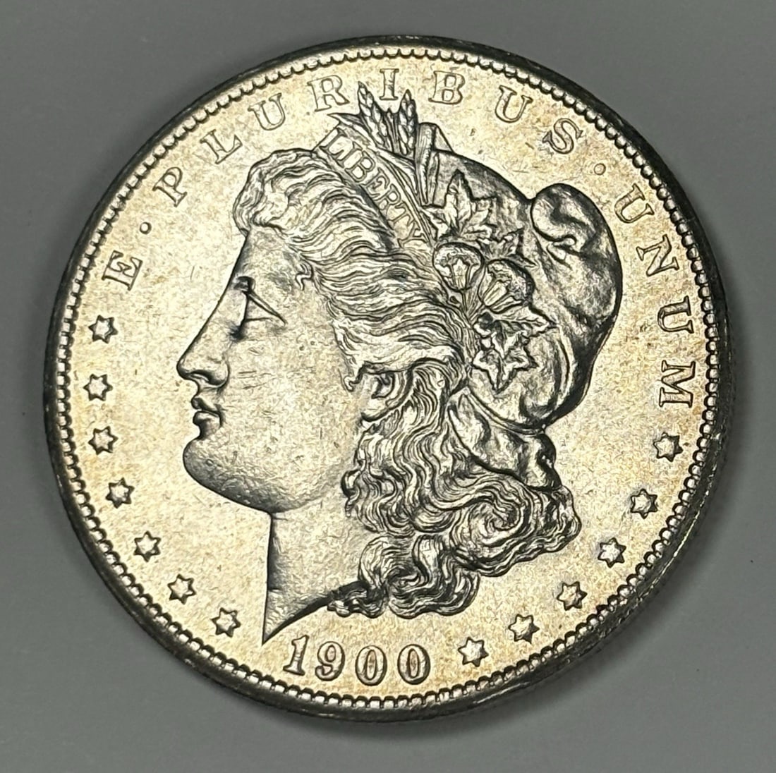 MORGAN DOLLAR 1900-S UNCIRCULATED: MORGAN DOLLAR 1900-S UNCIRCULATED The 1900-S Morgan Dollar is a rare and historic coin, featuring a 0.900 silver composition and a San Francisco mint mark. This uncirculated coin is a unique addition 
