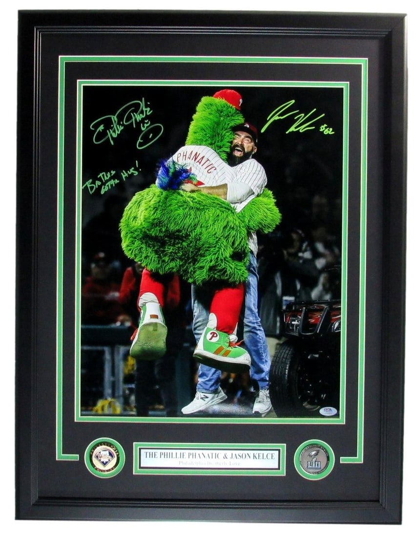 Jason Kelce/ Phillies Phanatic Dual-Signed/ Insc 16x20 Photo Framed PSA/ DNA 211025: Jason Kelce/ Phillies Phanatic Dual-Signed/ Insc 16x20 Photo Framed PSA/ DNA 211025 Dual-signed 16x20 photo of Jason Kelce and the Phillies Phanatic, framed in a high-quality PSA/DNA-verified display.