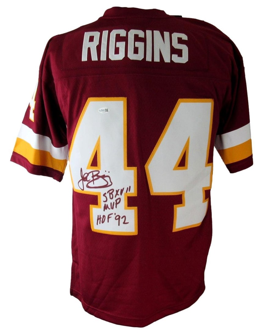 John Riggins Signed HOF Insc Maroon Football Mitchell & Ness Jersey Redskins JSA: John Riggins Signed HOF Insc Maroon Football Mitchell & Ness Jersey Redskins JSA Signed by John Riggins, a member of the Pro Football Hall of Fame, this Mitchell & Ness maroon jersey features an inscr