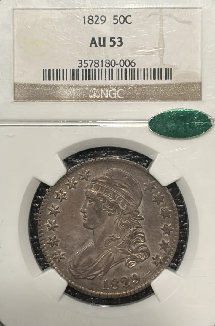 AU53 NGC HALF DOLLAR CAC BUST 1829: AU53 NGC HALF DOLLAR CAC BUST 1829 NGC and CAC certified, this 1829 half dollar boasts a silver composition and a grade of AU 53, offering a glimpse into the early years of American coinage. The coin'
