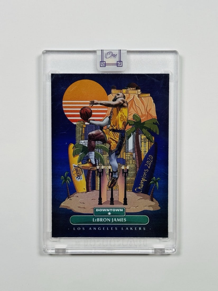 2021-22 PANINI ONE AND ONE LEBRON JAMES #1 DOWNTOWN: 2021-22 PANINI ONE AND ONE LEBRON JAMES #1 DOWNTOWN The 2021-22 Panini One & One LeBron James #1 Downtown card features an autograph from the NBA legend, showcasing his signature on a standard-sized c