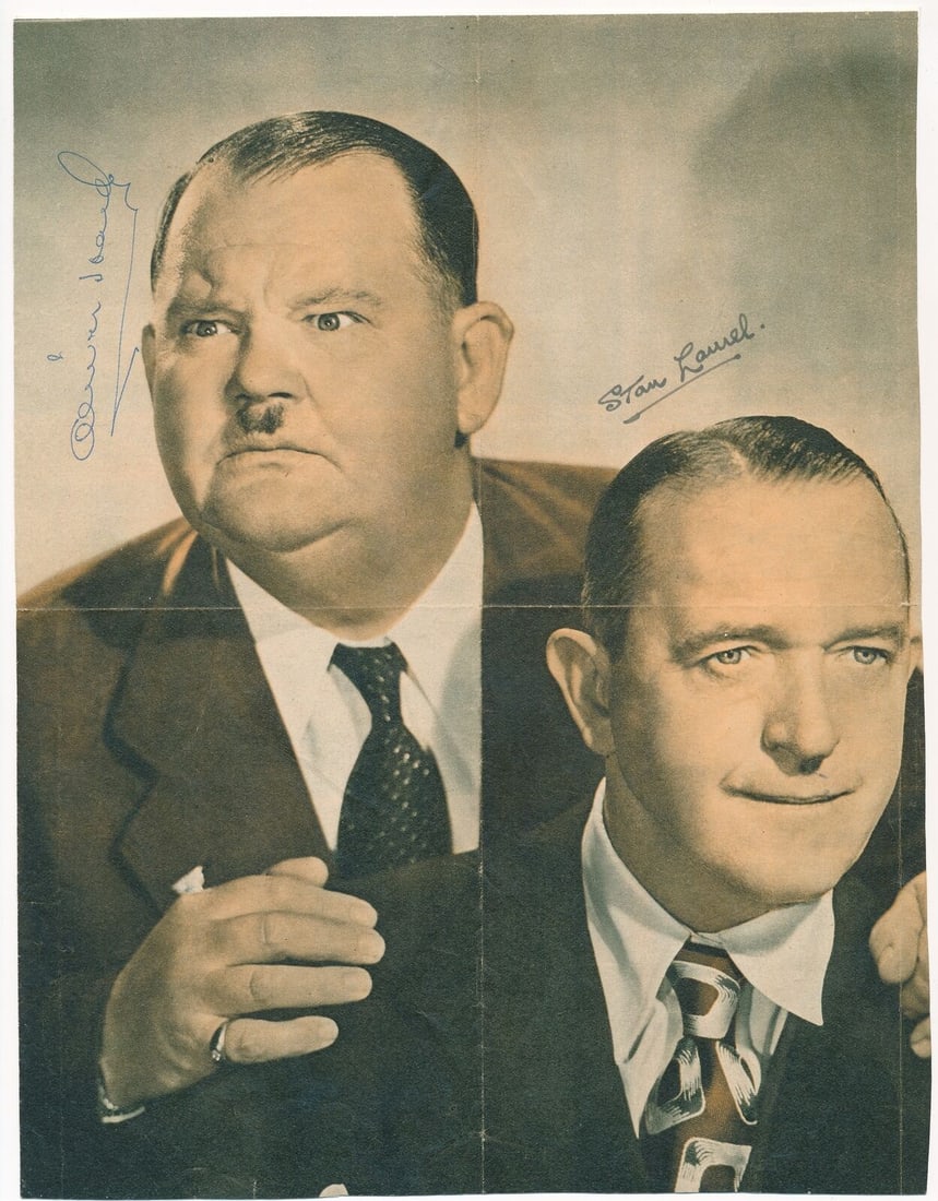 Stan Laurel/ Oliver Hardy Dual-Signed 8x10 Vintage Magazine Photo PSA/ DNA 167640: Stan Laurel/ Oliver Hardy Dual-Signed 8x10 Vintage Magazine Photo PSA/ DNA 167640 Stan Laurel and Oliver Hardy's iconic duo is captured in this vintage 8x10 magazine photo, bearing the dual