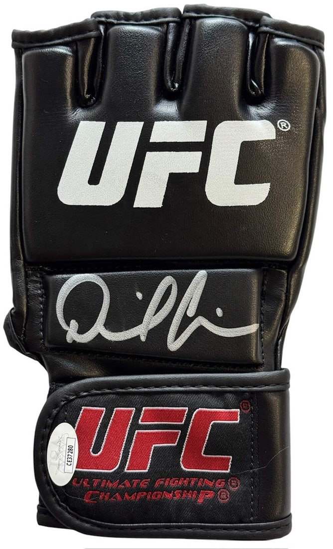 Daniel Cormier Signed UFC Fighting Glove by JSA: Daniel Cormier Signed UFC Fighting Glove by JSA Signed by UFC legend Daniel Cormier in silver sharpie, this authentic JSA-certified glove bears a unique mark from one of the sport's most accomplished 