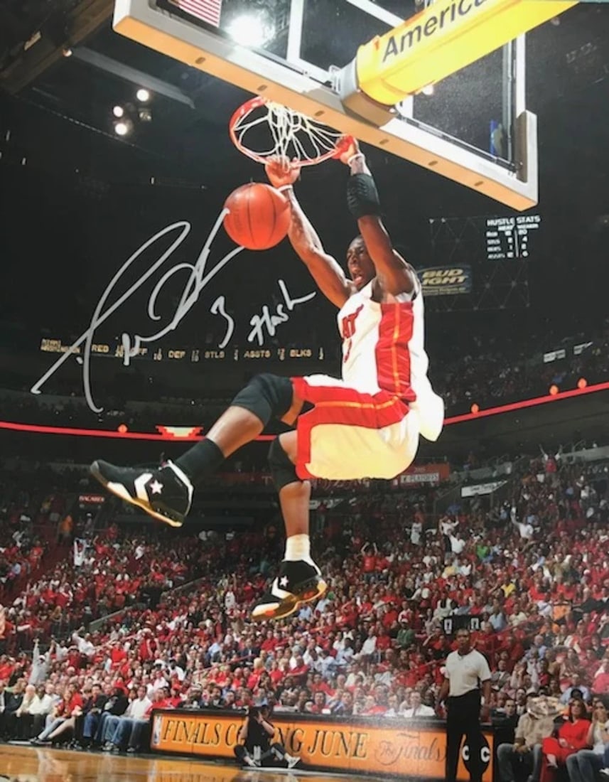 Wade Dwyane Autographed 2 Dunk Flash 16x20 Photo: Wade Dwyane Autographed 2 Dunk Flash 16x20 Photo Dwyane Wade's "Flash" 2 Hand Dunk photo, signed in silver sharpie across the front, is a unique piece of sports memorabilia. The 16x20 photo captures