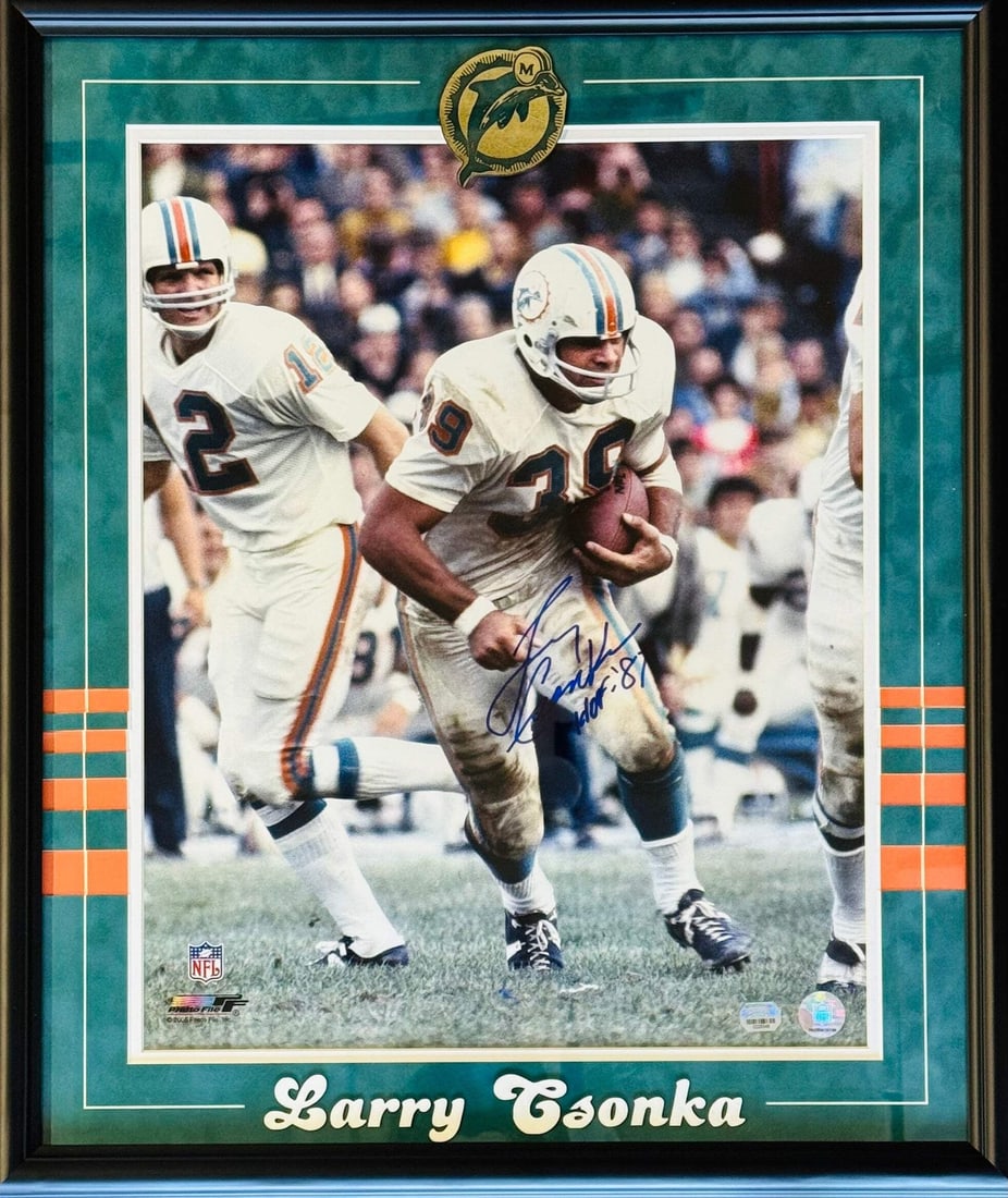 Csonka Framed Autographed Photo Memories Larry Mounted 16x20: Csonka Framed Autographed Photo Memories Larry Mounted 16x20 Signed in blue sharpie across the front of the photo, this 16x20 framed autographed photo bears the inscription "HOF 87", a notable nod to 