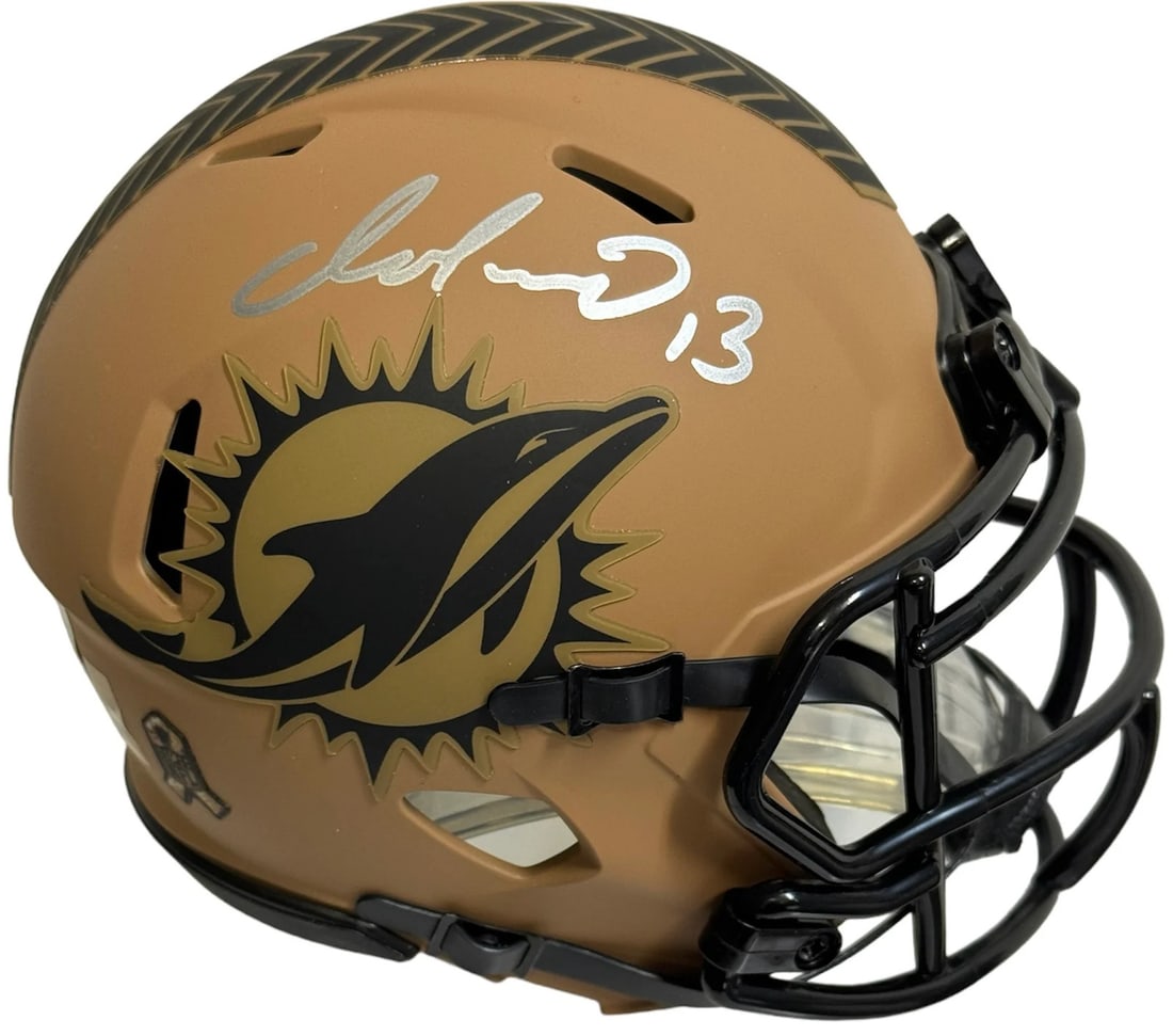 Mini Helmet Salute To Service Dolphins Autographed By Dan Marino: Mini Helmet Salute To Service Dolphins Autographed By Dan Marino Signed in silver paint pen across the side of the mini helmet, this autographed Dolphins Salute To Service mini helmet bears the mark
