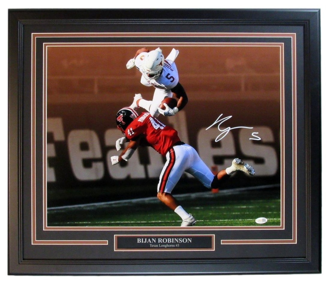 Signed Bijan Robinson Autographed 16x20 Texas Longhorns Photo Framed: Signed Bijan Robinson Autographed 16x20 Texas Longhorns Photo Framed Bijan Robinson's bold signature adds a touch of Texas pride to this 16x20 photo of the Longhorns football team. Framed to perfectio