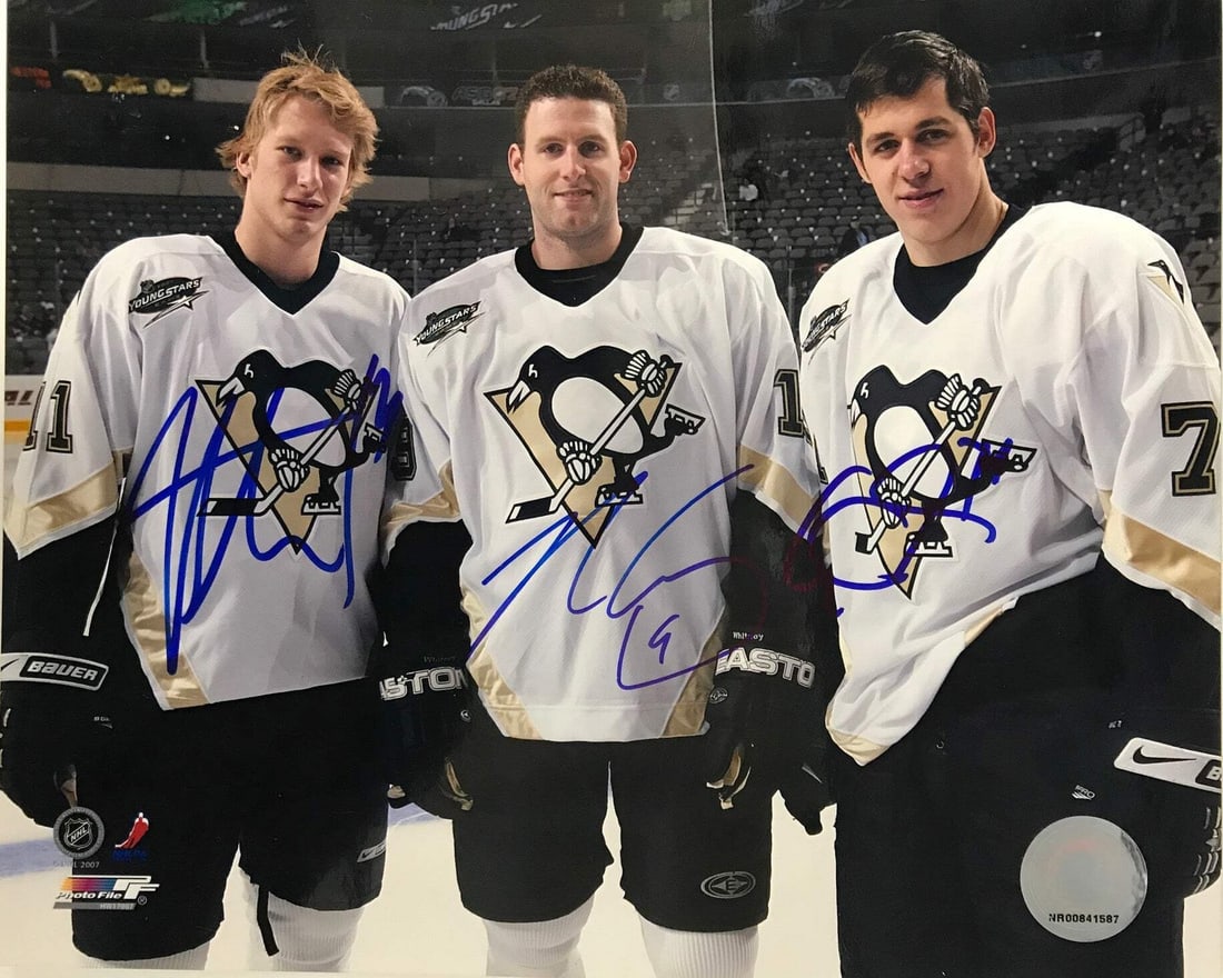 Malkin Jordan Staal Whitney Ryan Autographed 8x10 Photo: Malkin Jordan Staal Whitney Ryan Autographed 8x10 Photo Evgeni Malkin, Jordan Staal, and Ryan Whitney have signed this 8x10 photo in blue sharpie across the front. The photo features the three NHL pla