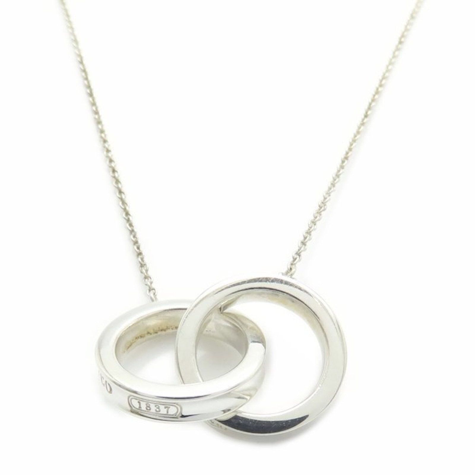 TIFFANY Silver 925: TIFFANY Silver 925 Silver Tiffany Necklace, 925. This gently used necklace features a silver 925 chain with a small, delicate pendant. Minor scratches or light marks are present, but the overall condi