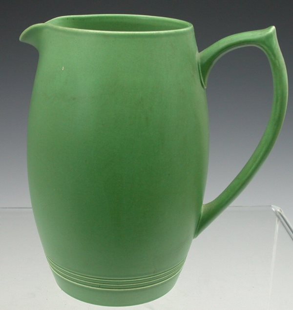A Wedgwood lemonade jug by Keith Murray, of tall o: A Wedgwood lemonade jug by Keith Murray, of tall ovoid form with celadon frieze, stamped marks 21cm high