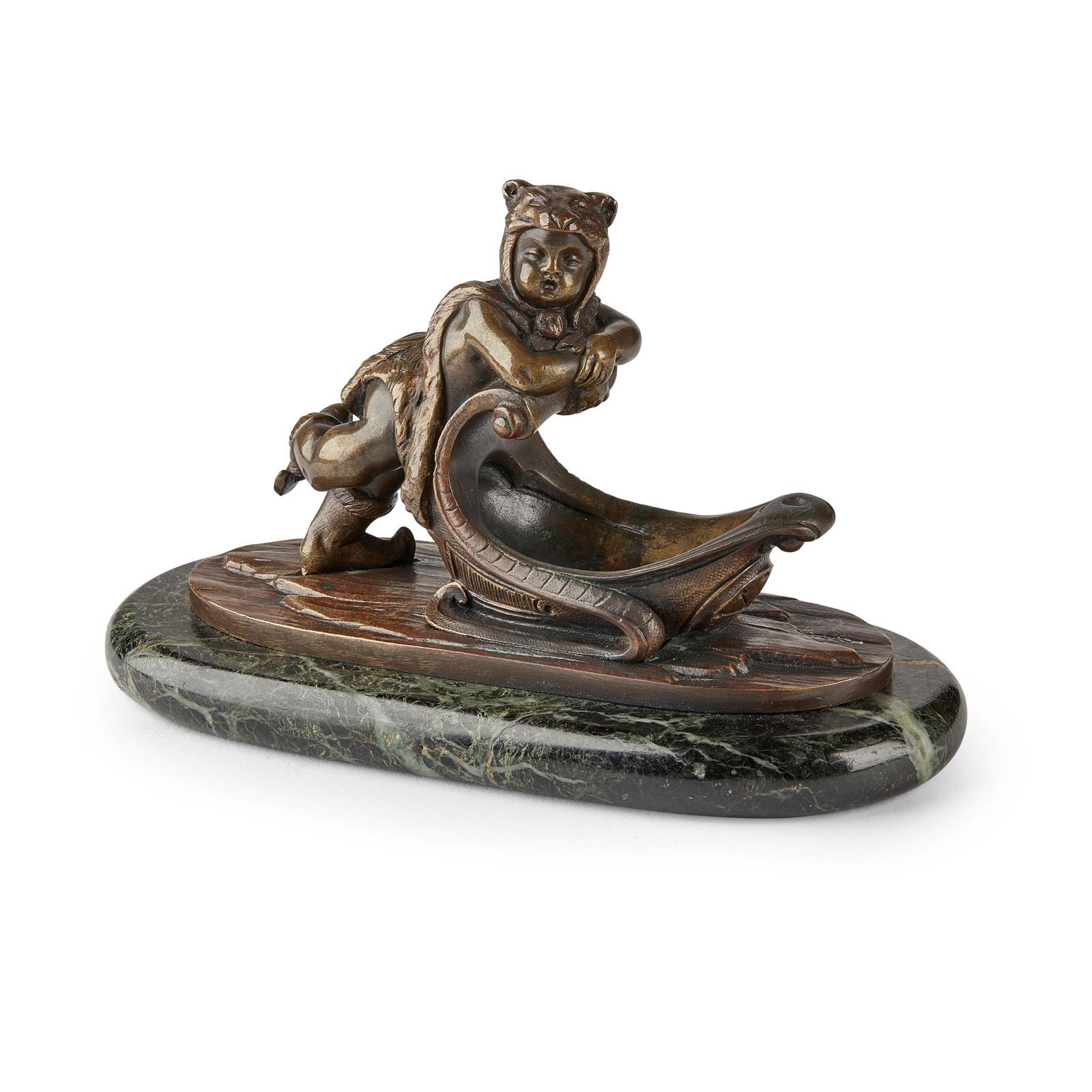 CONTINENTAL BRONZE FIGURE EMBLEMATIC OF WINTER LATE: depicting a putto wearing a pelt and ice skates, pushing on a sleigh, on an oval verde antico plinth (Dimensions: 10cm high)(10cm high)