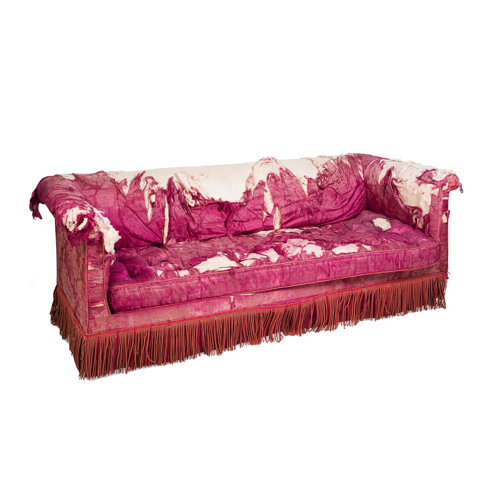 âœ VICTORIAN MAHOGANY UPHOLSTERED SOFA MID-19TH: with a low back and outscrolled arms above a long cushion seat, raised on ring-turned legs with bulbous feet, with brass caps and castors; covered in distressed red damask with a deep fringe trim (Dim