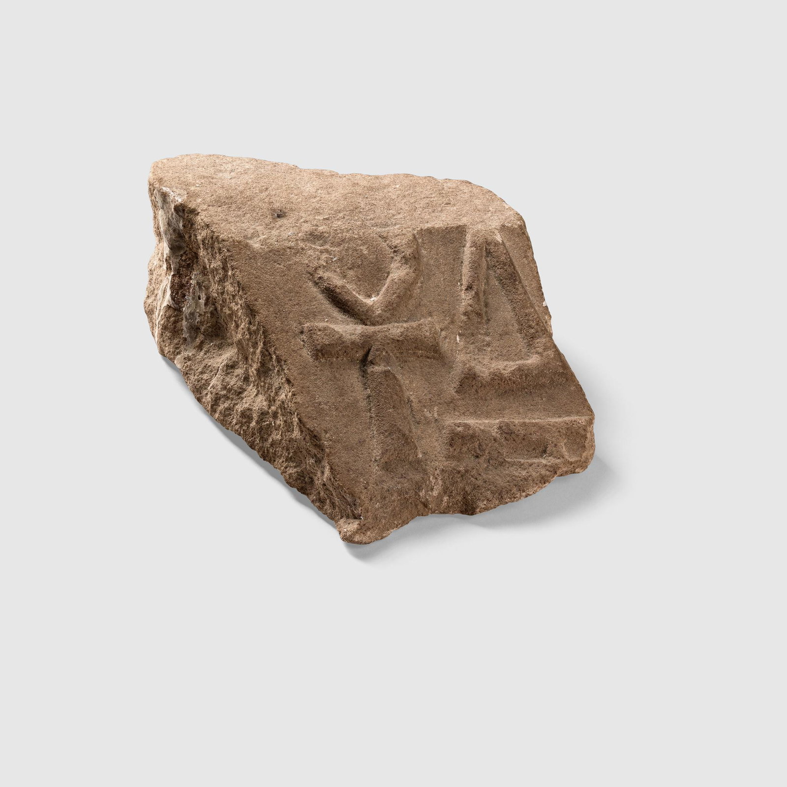 ANCIENT EGYPTIAN CARVING FRAGMENT KOM OMBO, EGYPT,: carved sandstone, with an ankh in low relief, the back with a note written in black ink reading "Kom Ombo 27-12-62" (Dimensions: 16.5cm tall) (16.5cm tall) Footnote: Provenance: Jytte Solberg, Denmark
