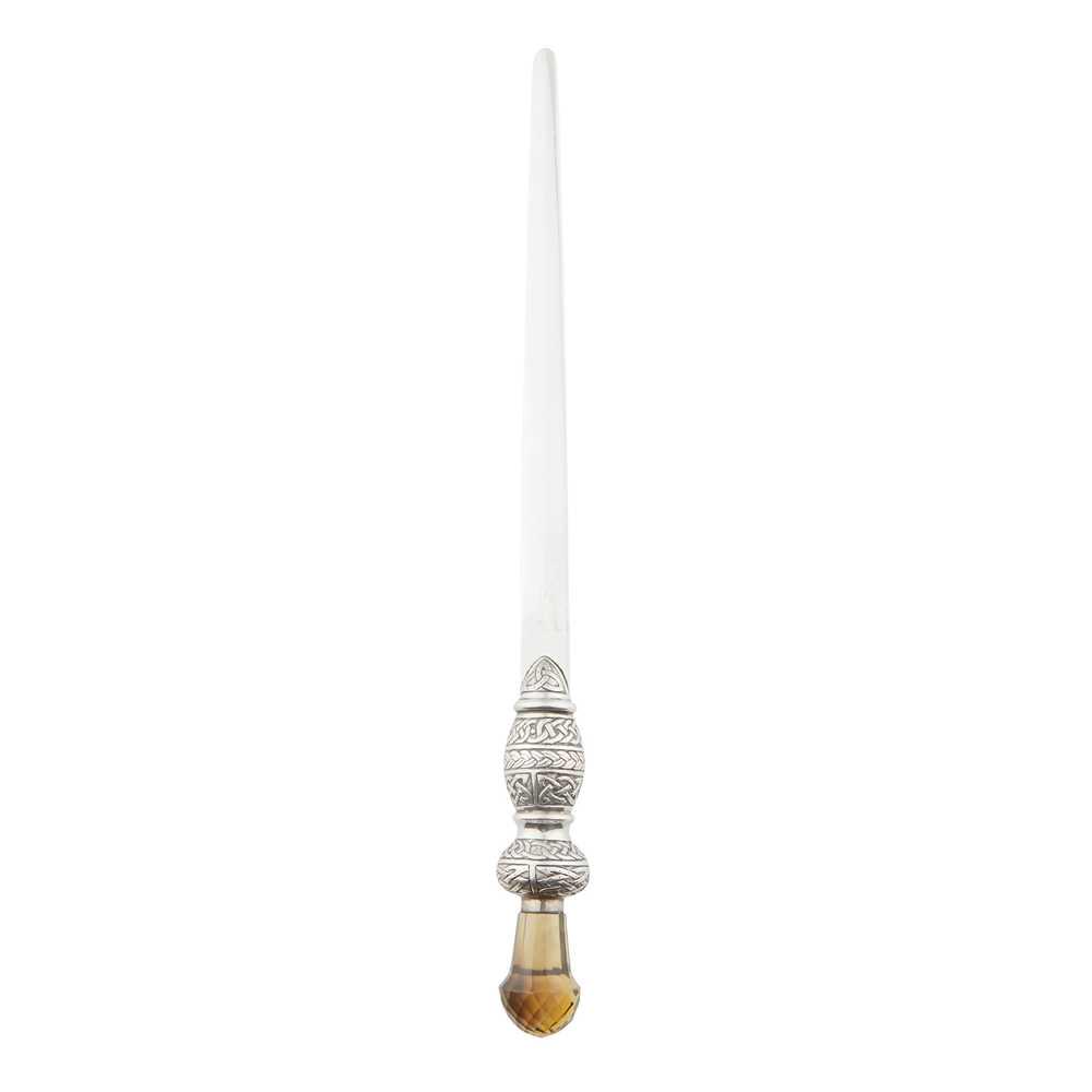 An Edwardian silver and citrine page turner: Thomas Smith & Sons (possibly), Edinburgh 1908, the tapered blade with hallmarks, the handle of baluster form with all-over Celtic knotwork decoration, the finial set with a facetted citrine (Dimensio