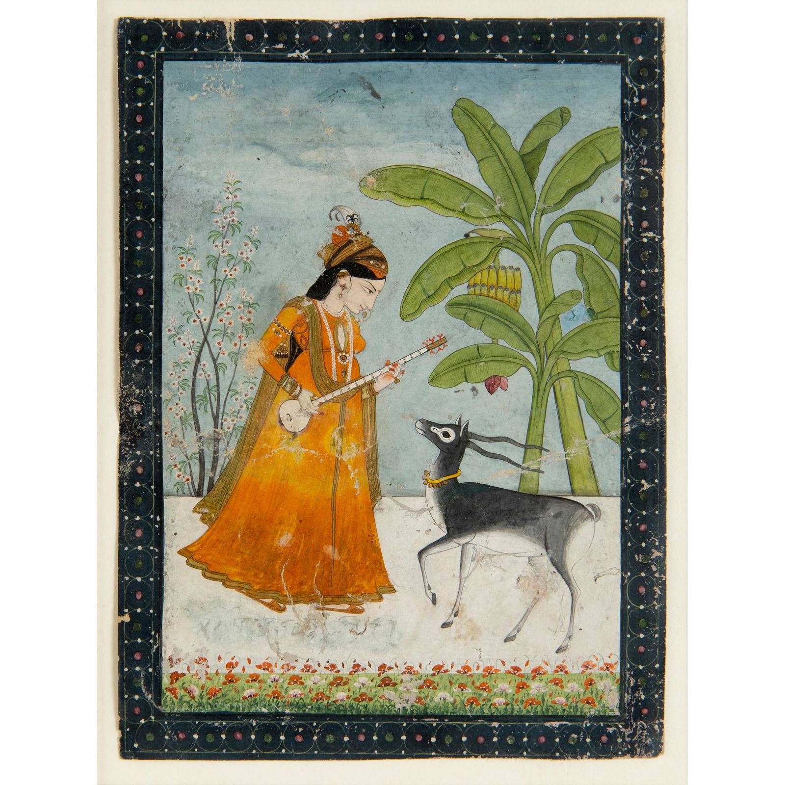 TODI RAGINI: A PRINCESS PLAYING A SITAR WITH A DEER IN: TODI RAGINI: A PRINCESS PLAYING A SITAR WITH A DEER IN A LANDSCAPE KANGRA, INDIA, EARLY 19TH CENTURY gouache and gold on paper, dark blue floral border (18cm x 13.5cm) Qty: (1) Footnote: Provenance: P