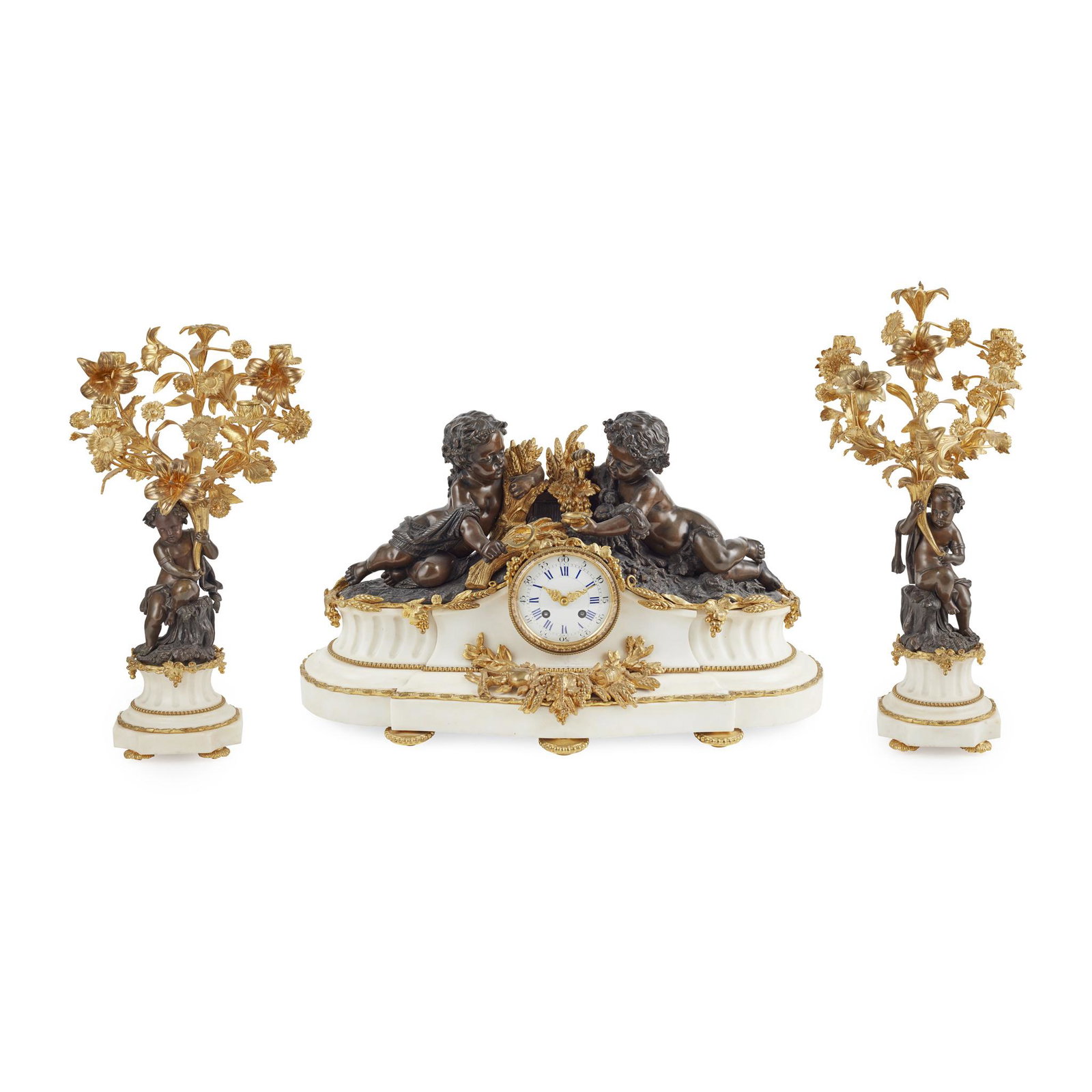FRENCH GILT AND PATINATED BRONZE AND MARBLE MANTLE: the white enamel dial with Roman and Arabic chapters and twin winding holes, in a waisted white marble case surmounted by a pair of putti emblematic of Autumn, the eight-day movement striking a bell a