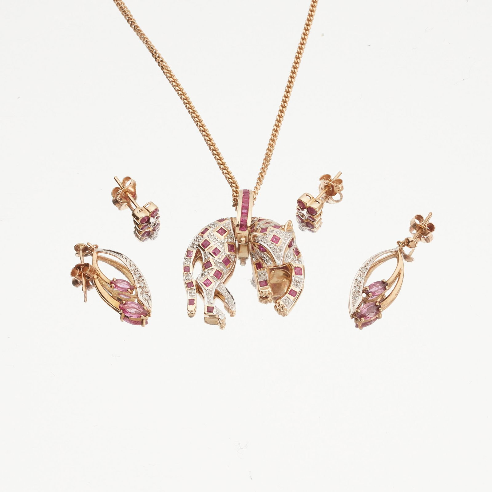 A ruby and diamond set pendant: A ruby and diamond set pendant modelled as a panther, set throughout with square-cut rubies and eight-cut diamonds, the loop bale channel set with a row of calibre-cut rubies, to a 9ct yellow gold fan