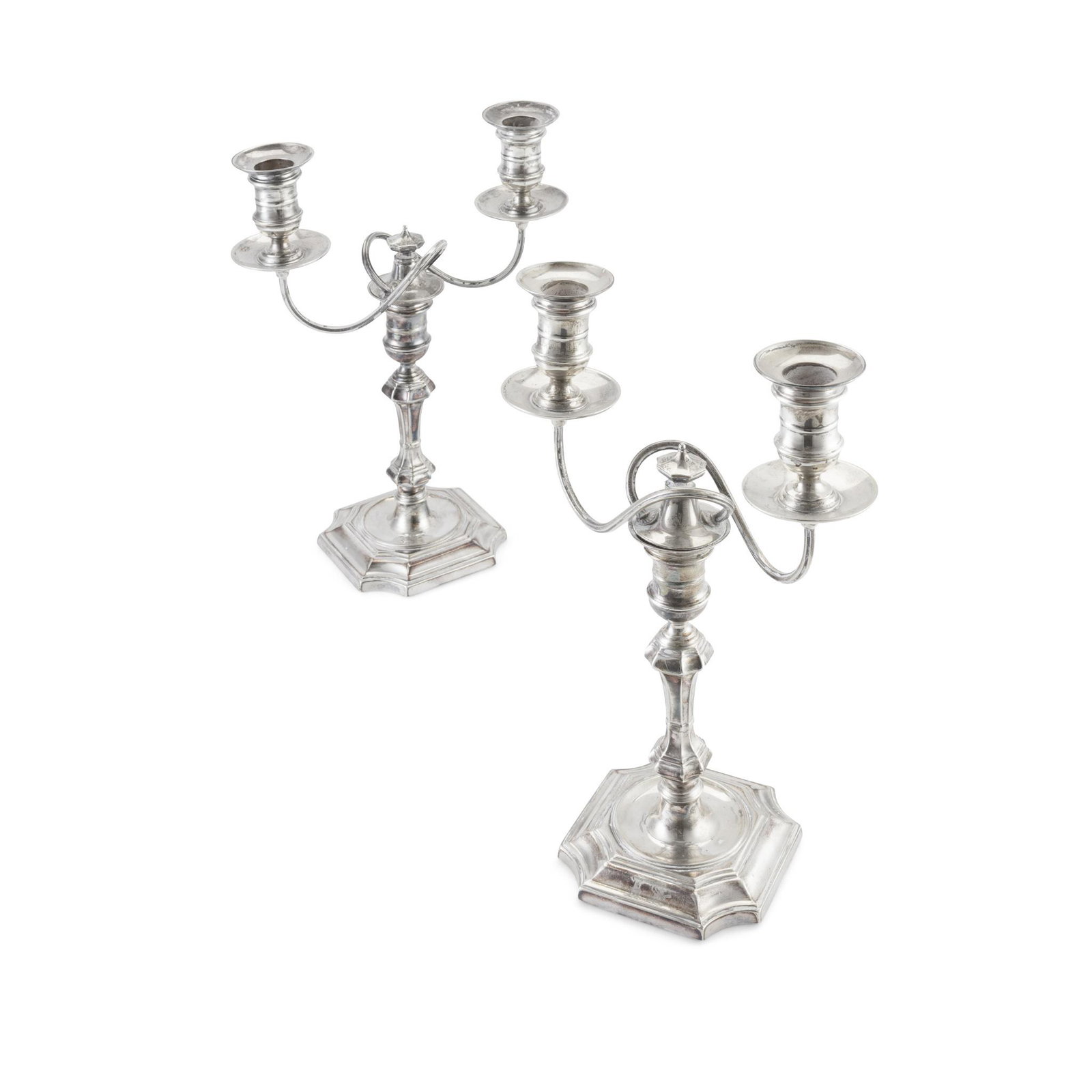A matched pair of Victorian George II style silver two: A matched pair of Victorian George II style silver two branch table candelabra Lambert & Co, London 1899 / 1901, the octagonal knopped columns to an octagonal foot with curved corners, the scrolling b
