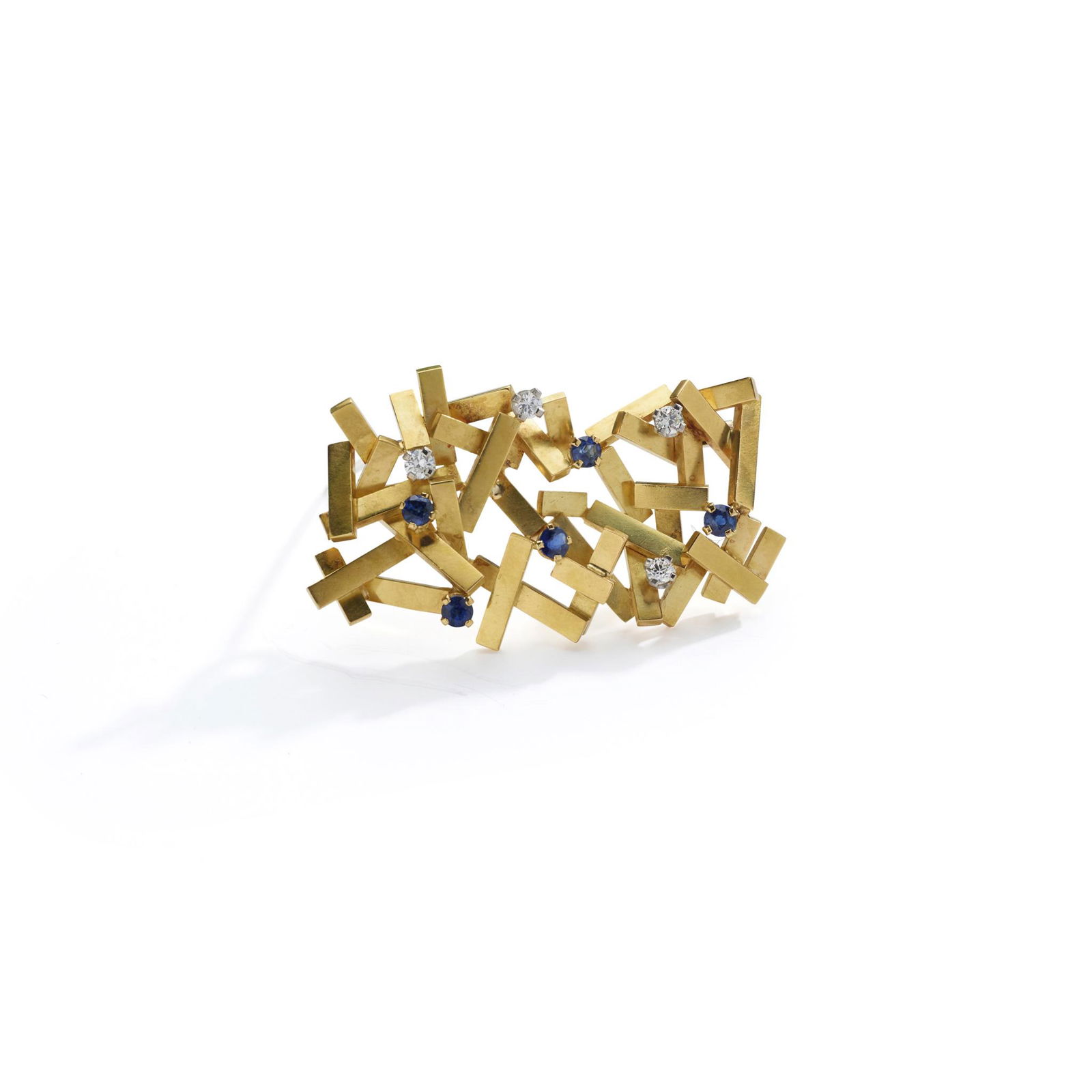 Â§ A sapphire and diamond-set pendant/brooch, by Andrew Grima, 1979: Â§ A sapphire and diamond-set pendant/brooch, by Andrew Grima, 1979 Designed as an openwork cluster of overlapping gold batons, accented by circular-cut sapphires and brilliant-cut diamonds, signed