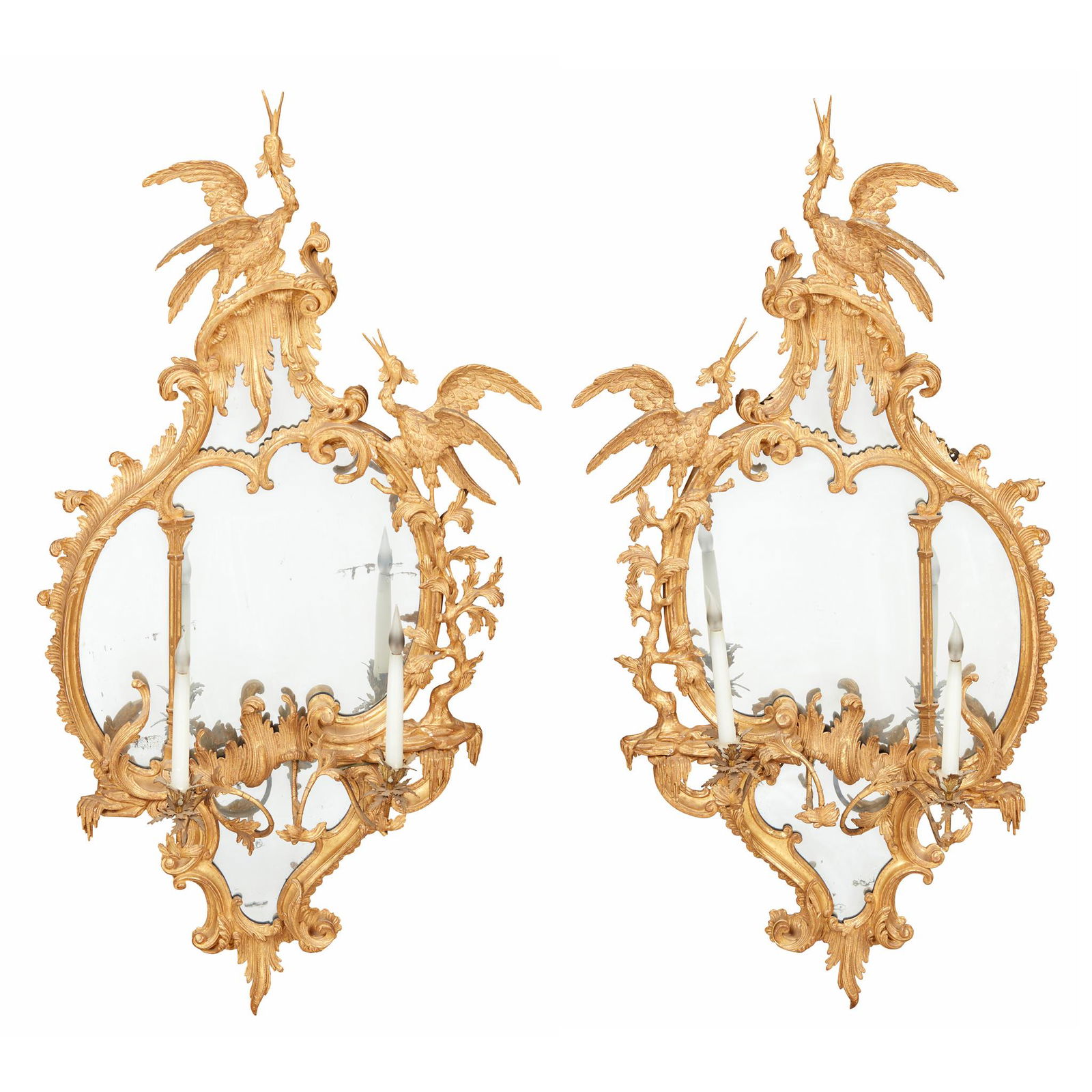 PAIR OF GEORGE III CARVED GILTWOOD GIRANDOLE MIRRORS, IN THE MANNER OF THOMAS JOHNSON MID 18TH: PAIR OF GEORGE III CARVED GILTWOOD GIRANDOLE MIRRORS, IN THE MANNER OF THOMAS JOHNSON MID 18TH CENTURY the asymmetrical shaped mirror plates enclosed by frames carved with rocaille, acanthus scrolls,